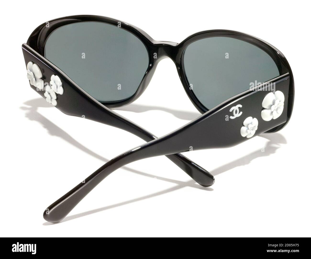 Black Chanel sunglasses with white flowers photographed on a white  background Stock Photo - Alamy