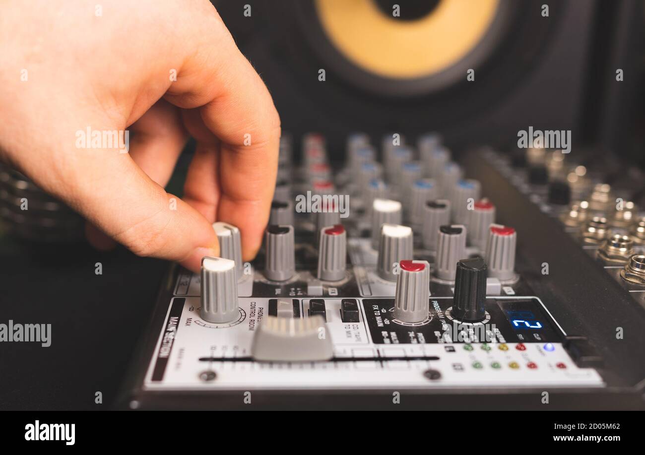 Sound engineer using control channels of studio mixer Stock Photo Alamy