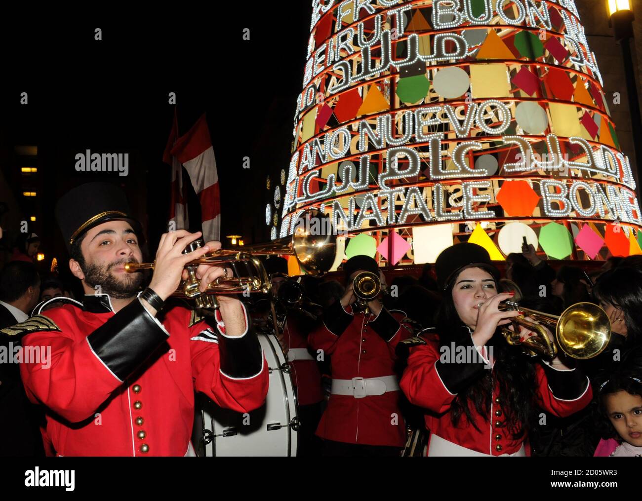 Musicians perform in front of a Christmas tree depicting the saying 'Merry Christmas and Happy New Year' in many languages, during the launch of 'Beirut Celebrates 2011' at a Christmas parade in downtown Beirut December 3, 2011. REUTERS/ Mohamed Azakir   (LEBANON - Tags: SOCIETY) Stock Photo