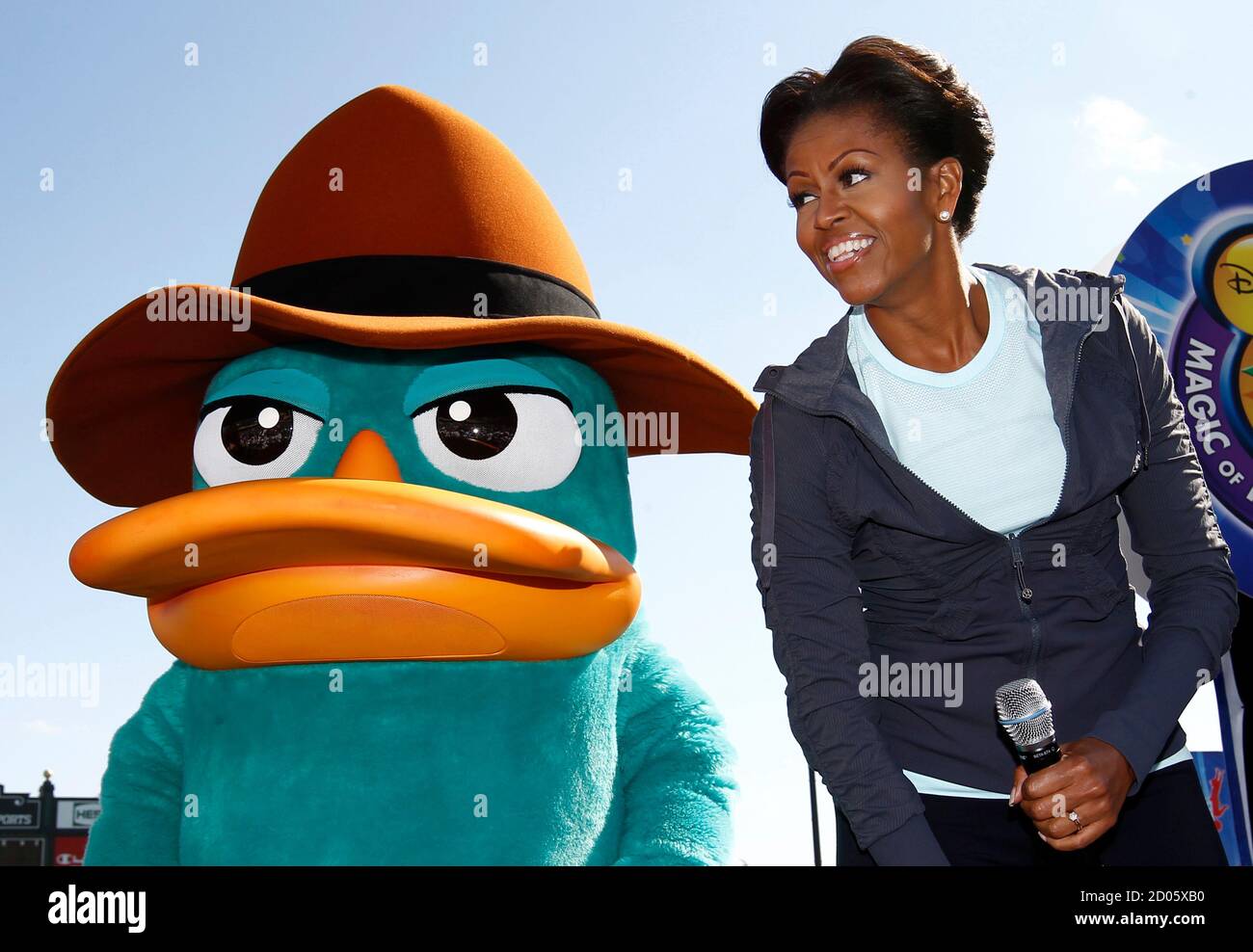 U S First Lady Michelle Obama Dances The Platypus Walk With Perry The Platypus From The Children S Tv Show Phineas And Ferb During A Let S Move Faith And Communities Physical Activity At Disney