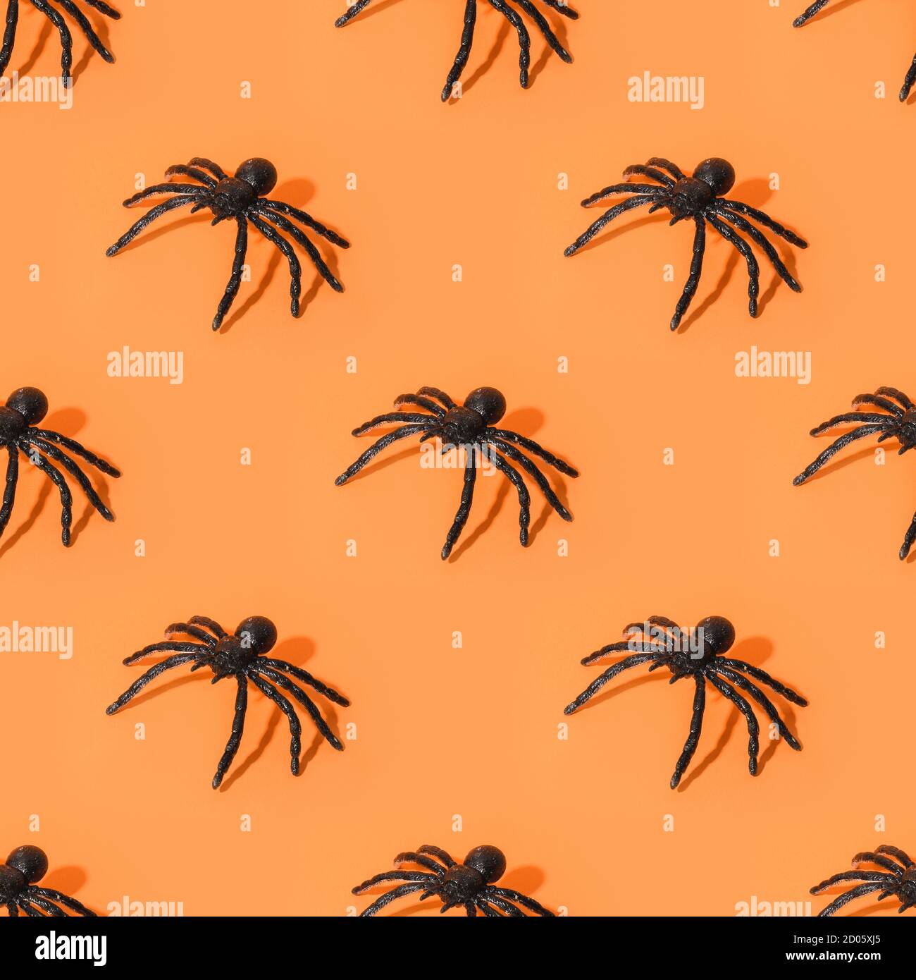 Seamless pattern of Halloween black spiders, fun decoration on orange ...