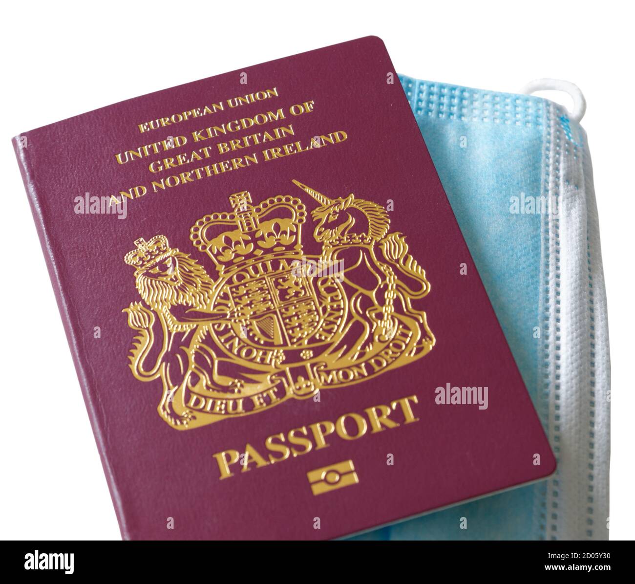 A UK passport and a mask, in response to travelling with the Covid-19 pandemic in 2020 Stock Photo