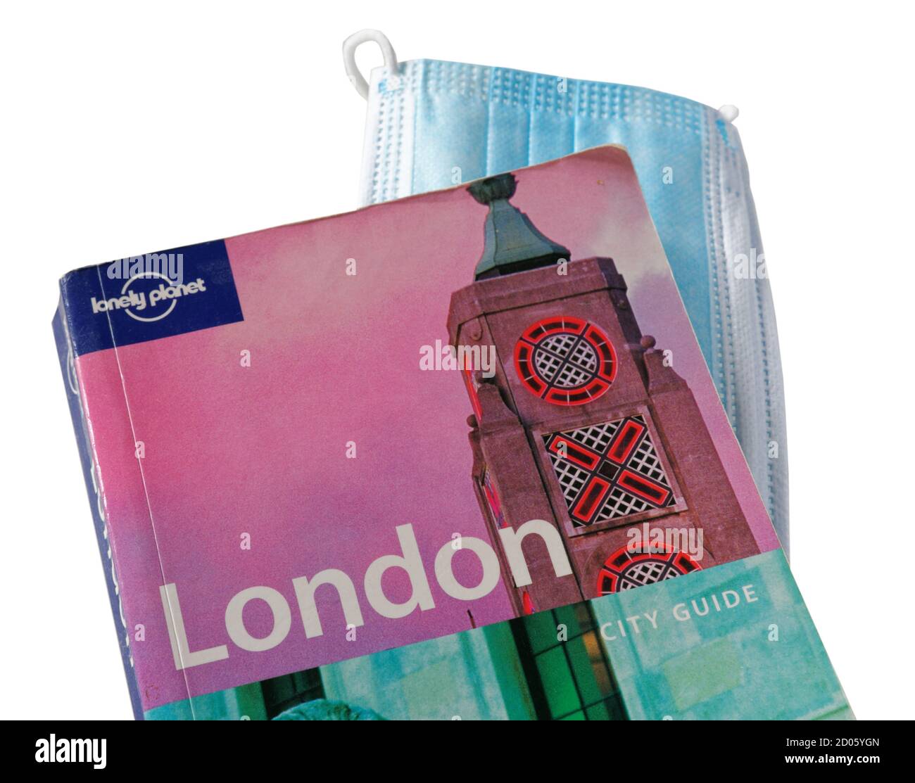 The Lonely Planet guidebook to London with a facemask, conceptual image of the Covid-19 pandemic in 2020 Stock Photo