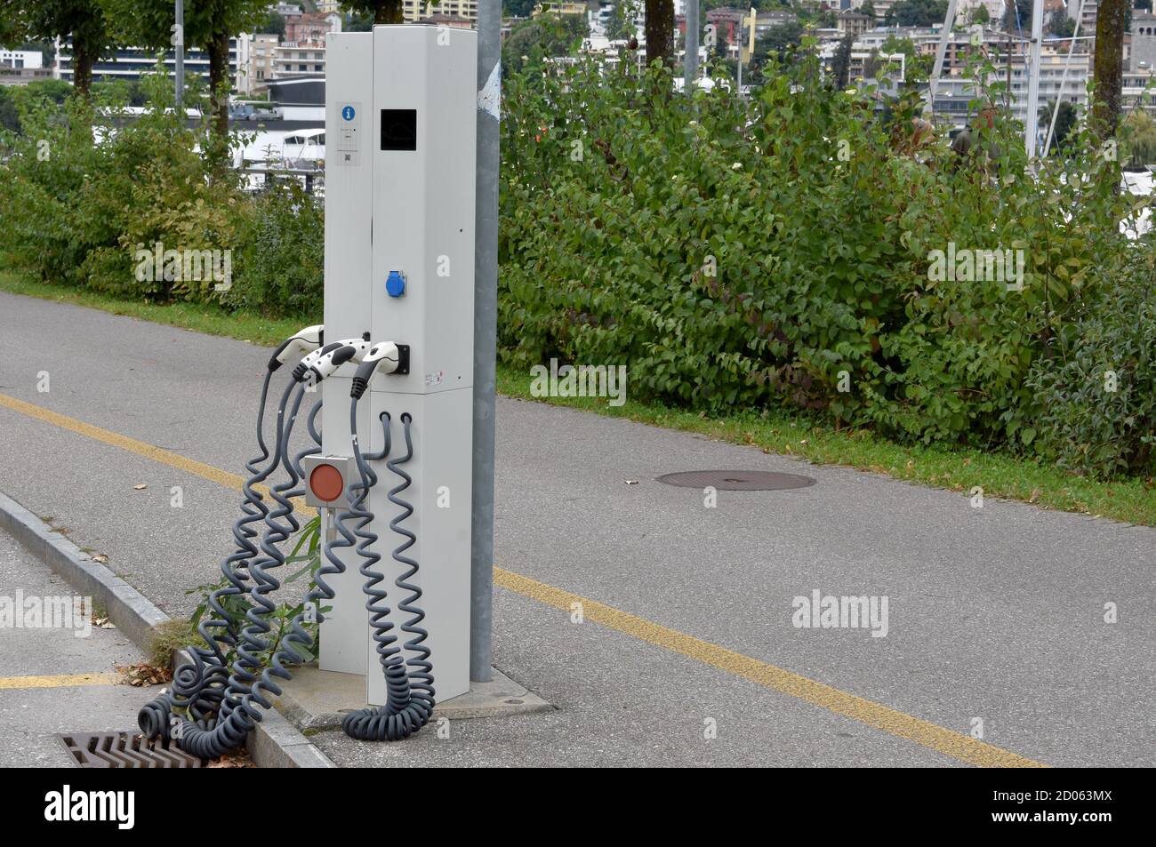 Charging station for electric cars and plug-in hybrid in the city on the street so that cars with alternative drive can charge while parking. Stock Photo