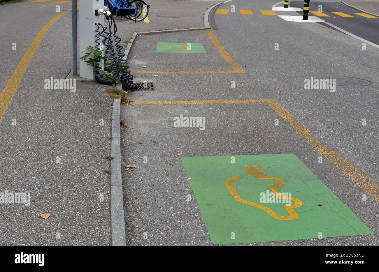 Parking places around an electric car charger. They are destined for vehicles that are supplied with energy while parking in order to save time. Stock Photo