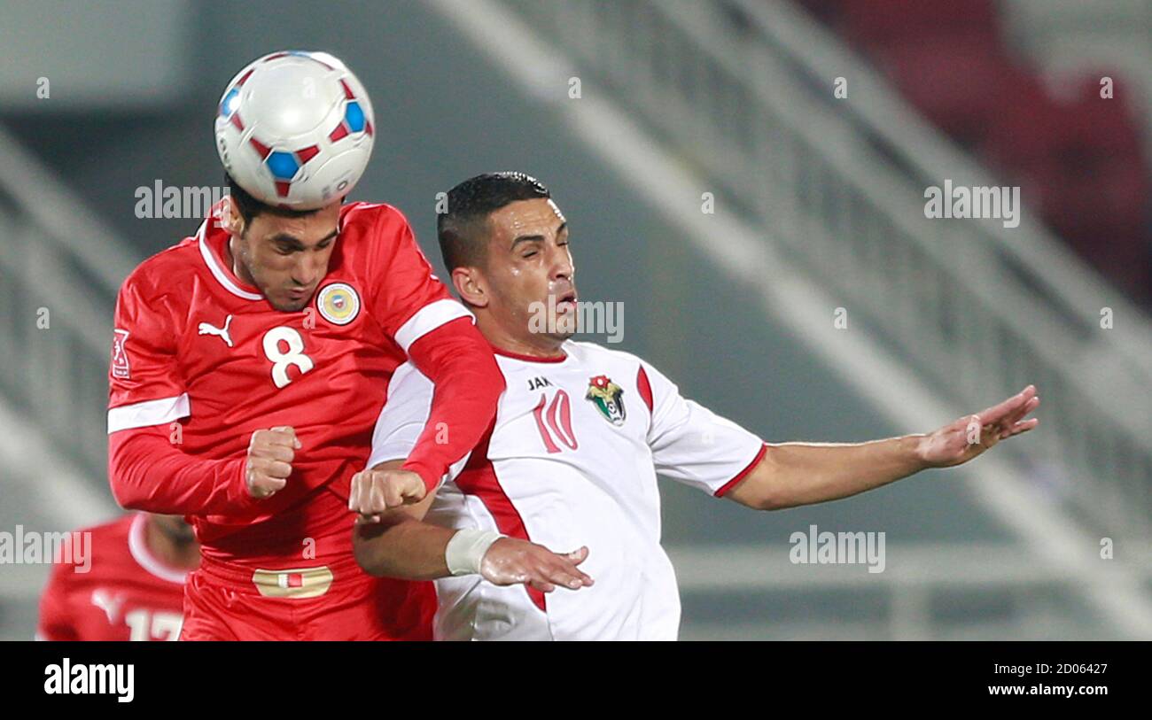 Jordan's Rakan Bani Khaled (R) fights for the ball with Bahrain's Sayed  Ahmed during their semifinal soccer match at the 8th West Asia cup (WAFF)  in Doha January 4, 2014. REUTERS/Mohammed Dabbous (