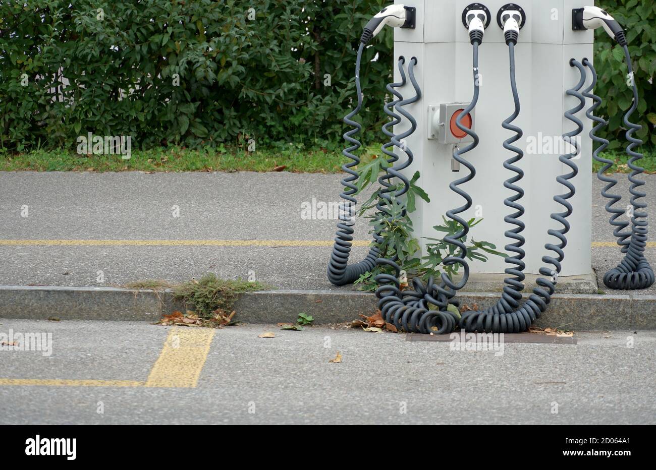 EV charging station for four electric or plug-in hybrid cars on the street. Stock Photo