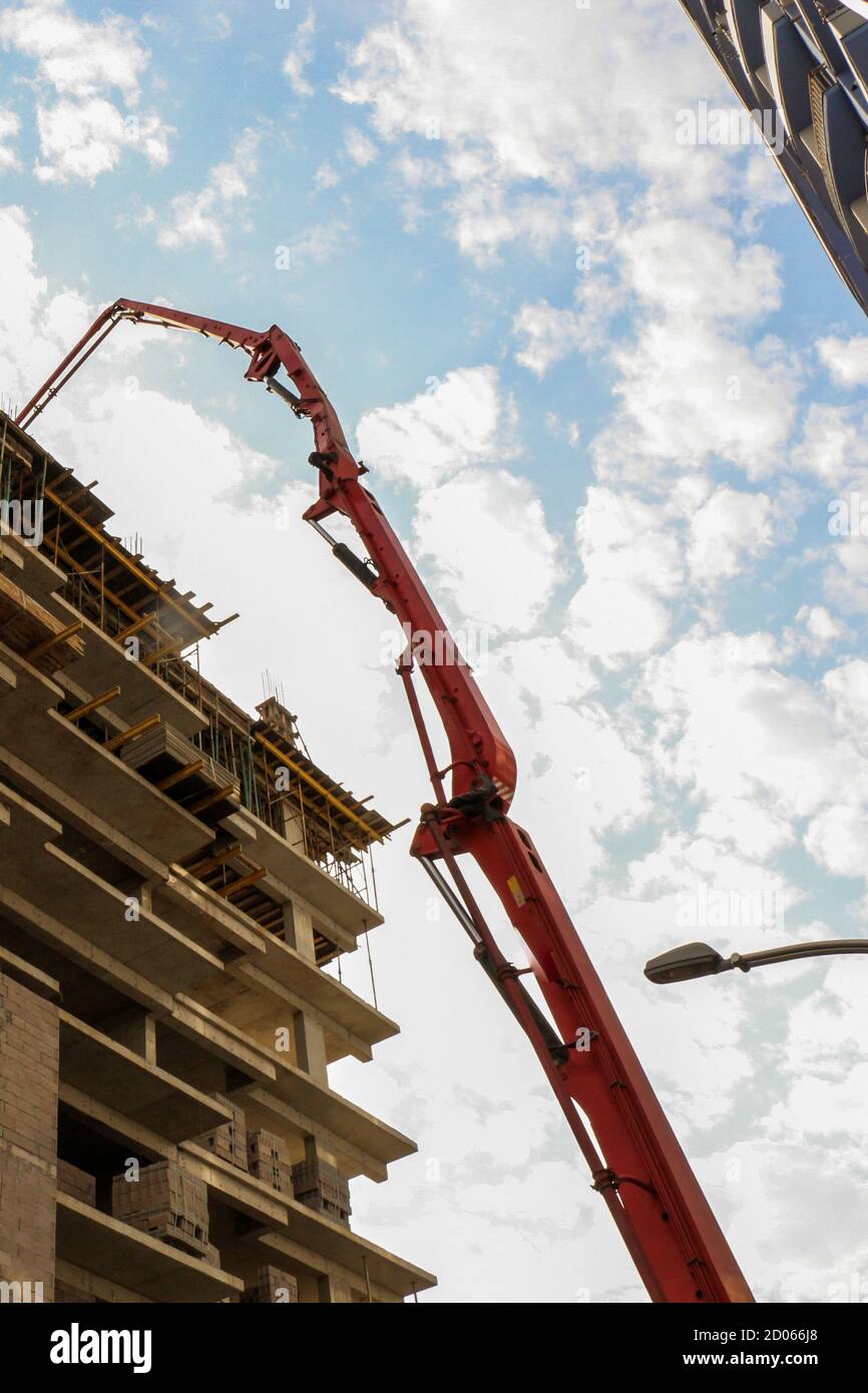 Vertical low angle shot of a crane near a building under construction ...