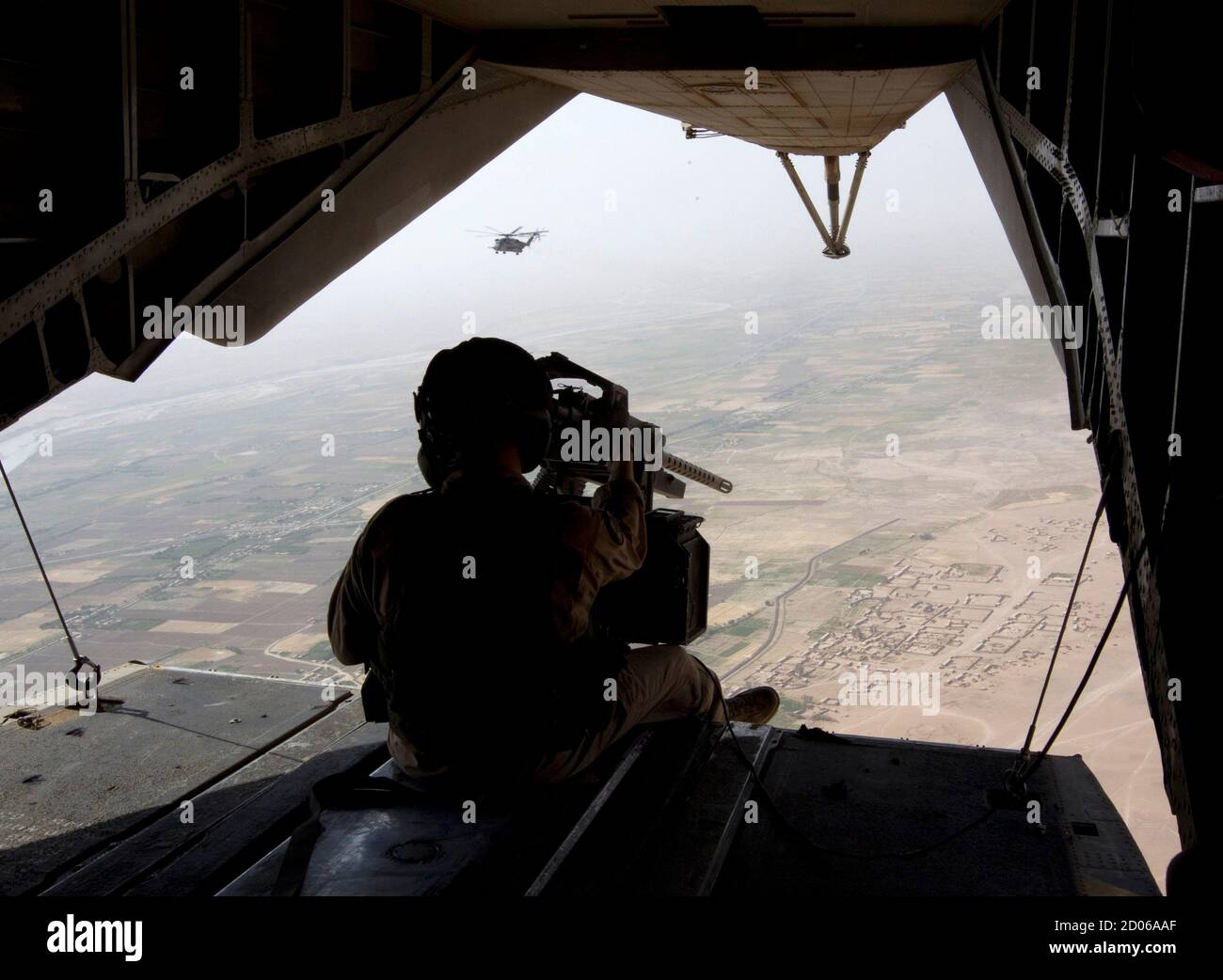 A gunner of U.S. Marines CH-53E Super Stallion helicopter flies during a Western Engagement operation over the Garsmir district of Helmand province, southern Afghanistan, July 7, 2011. U.S. Marines and Afghan security forces conducted a joint operation aiming to extend their presence west of Helmand river.    REUTERS/Shamil Zhumatov  (AFGHANISTAN - Tags: POLITICS MILITARY TRANSPORT) Stock Photo