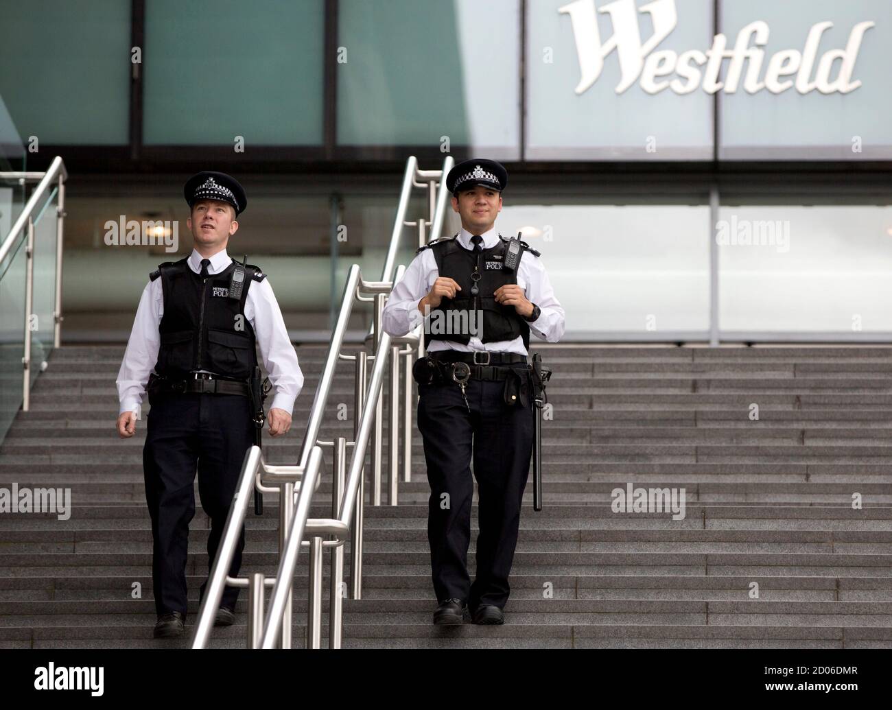 Police officers patrol around the Westfield Shopping Centre, a major gateway for visitors to the London 2012 Olympic Park, in Stratford, east London, July 19, 2012. REUTERS/Neil Hall (BRITAIN - Tags: SPORT OLYMPICS BUSINESS) Stock Photo