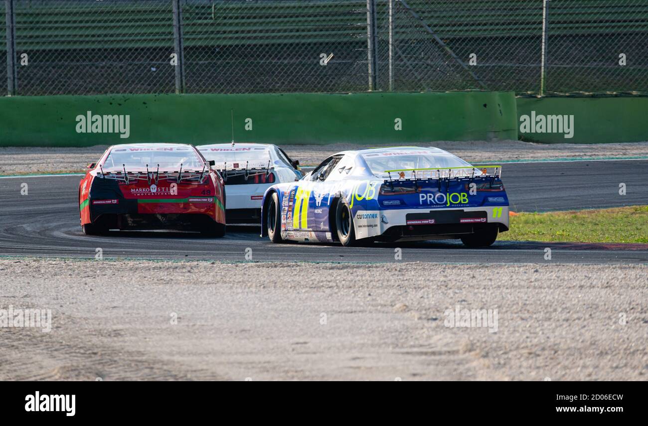 Vallelunga, Rome, Italy, 12 september 2020. American festival of Rome, Nascar Euro cars championship battle overtaking rear view at turn Stock Photo