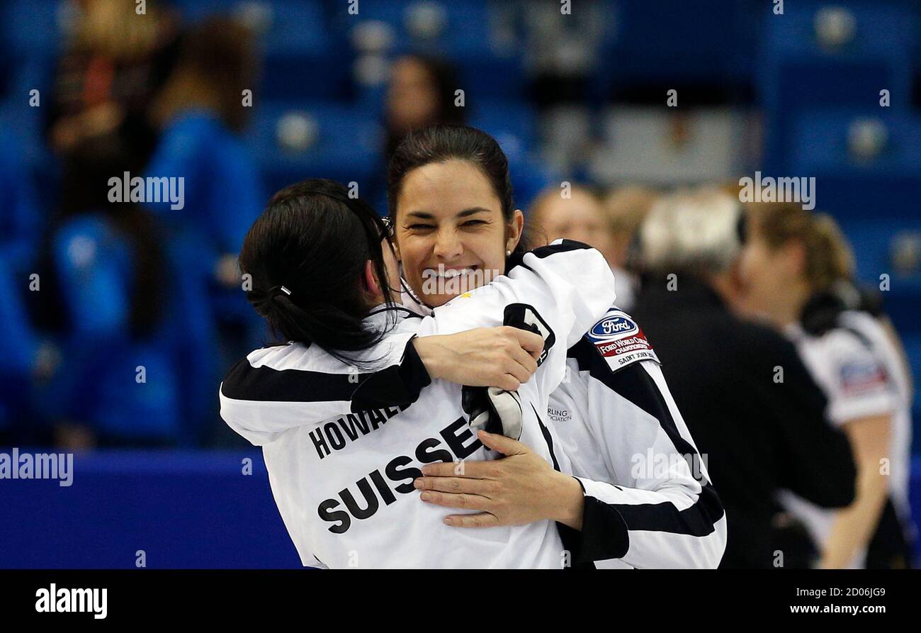 Switzerland's skip Binia Feltscher and alternate Carole Howald celebrate  after defeating South Korea during their semi-final game at the World  Women's Curling Championships in Saint John, New Brunswick, March 22, 2014.  REUTERS/Mathieu