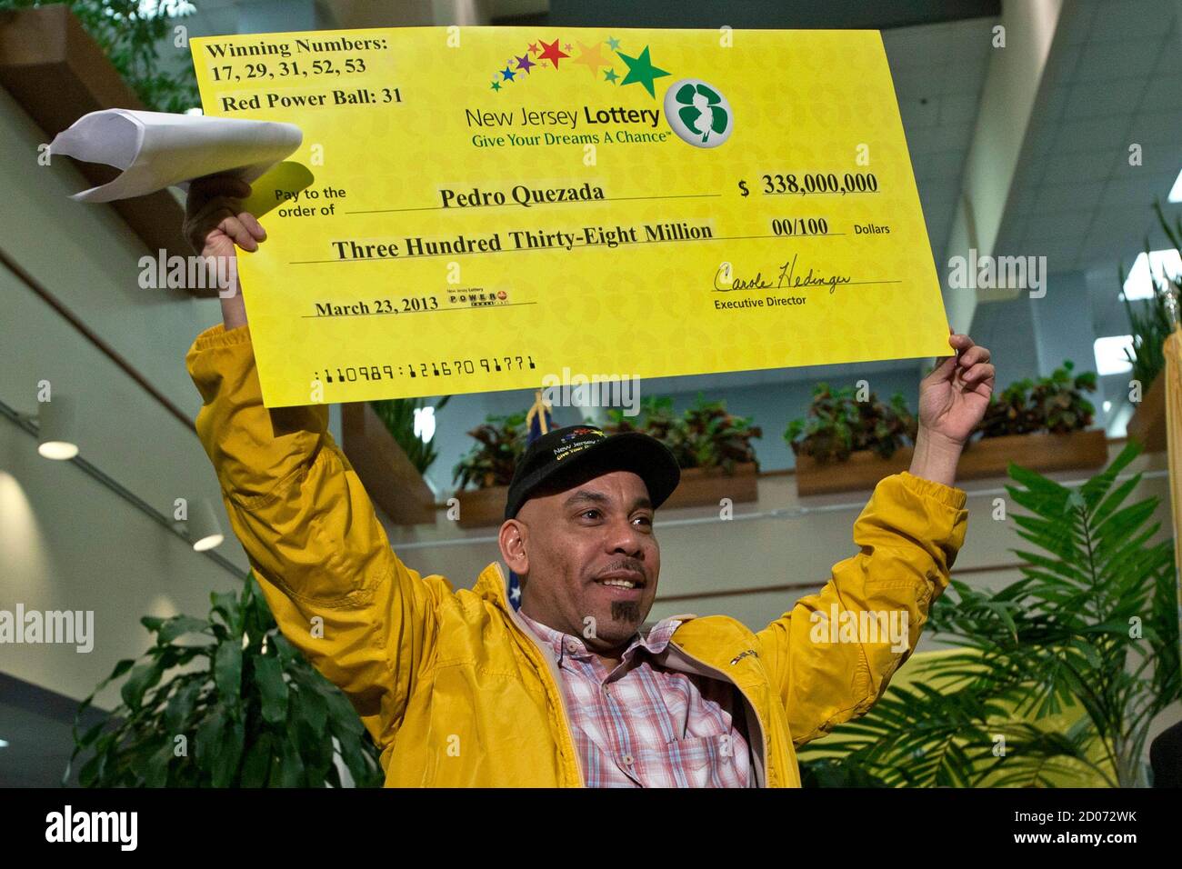 Pedro Quezada Holds Up The Promotional Powerball Jackpot Check Of 338 Million At The End Of A News Conference At The New Jersey Lottery Headquarters In Trenton March 26 2013 A New