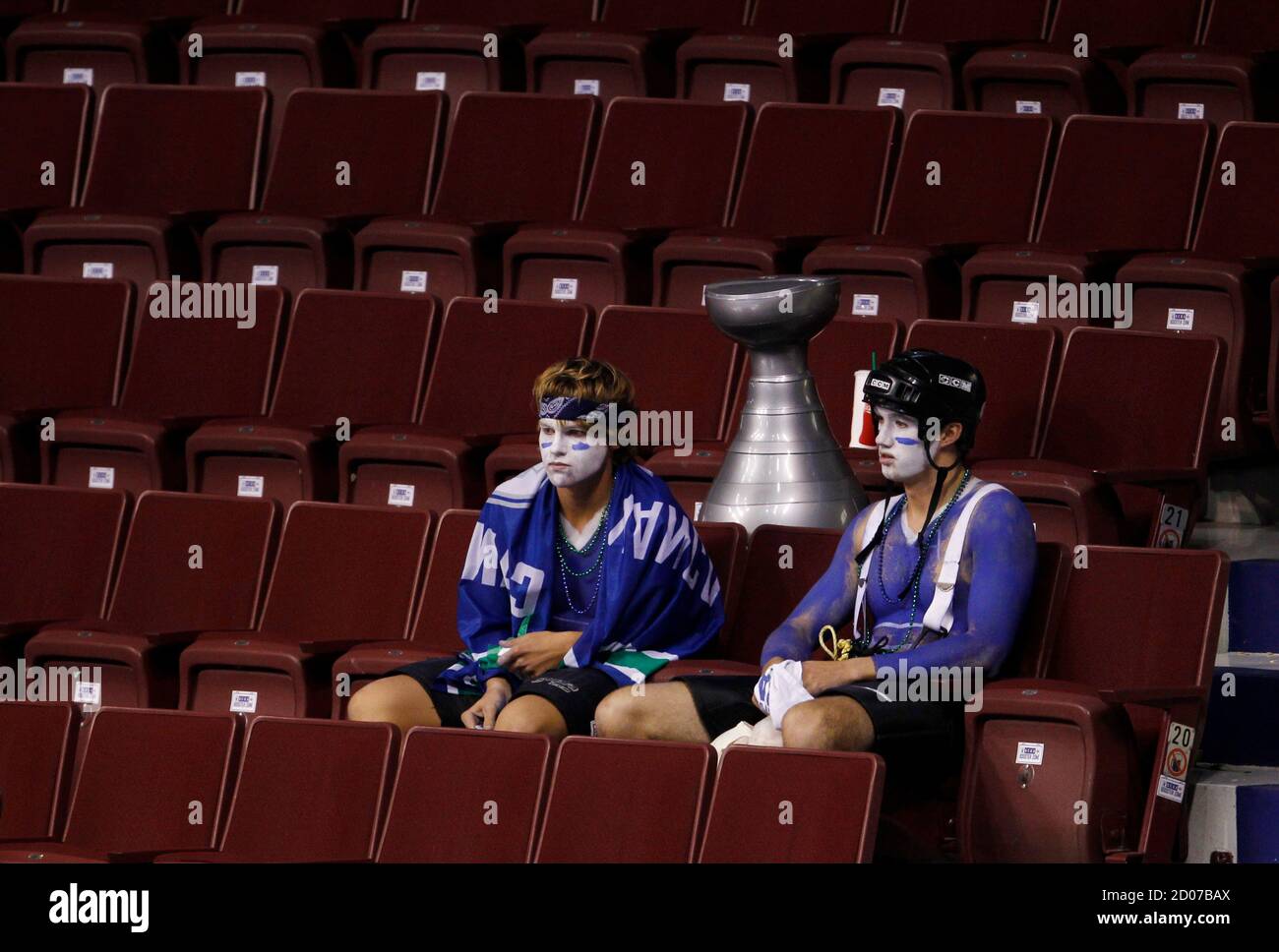 Vancouver Canucks fans sit dejected in the stands after the Canucks lost to  the Boston Bruins in Game 7 of the NHL Stanley Cup hockey playoff in  Vancouver, British Columbia June 15,