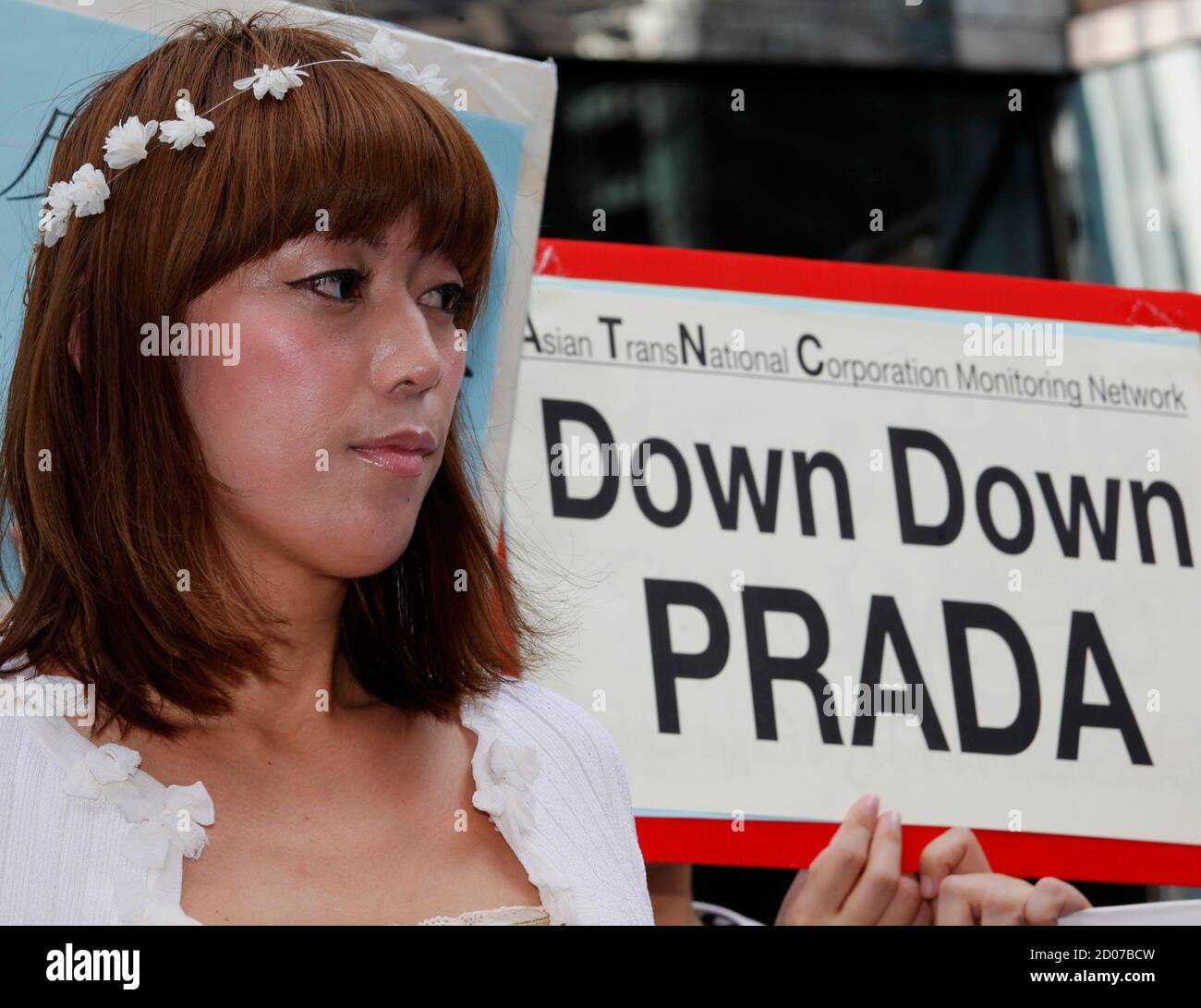 Rina Bovrisse, a former Prada manager in Japan, protests outside the Hong  Kong Stock Exchange during the debut of Prada SpA in Hong kong June 24,  2011. Italian fashion house Prada SpA