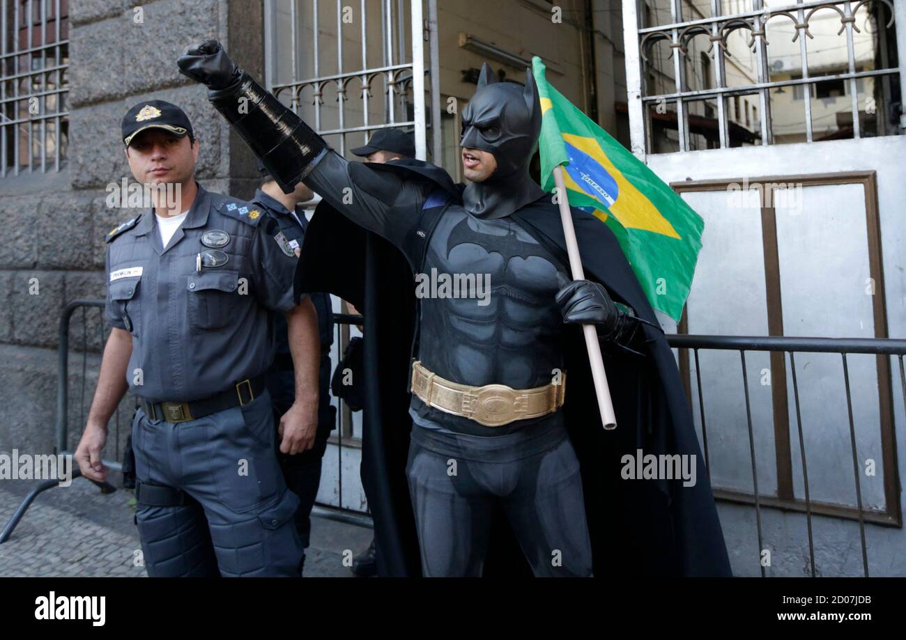 An anti-government demonstrator dressed as comic book superhero Batman  gestures with a Brazilian flag at a protest during Brazil's Independence  Day in Rio de Janeiro, September 7, 2013. The protesters called on