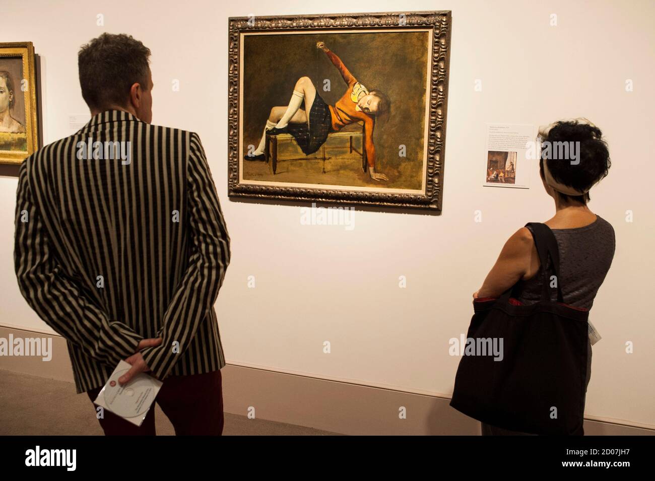 A woman looks at the painting entitled "Therese on a bench seat" by French  artist Balthus at the Metropolitan Museum of Art\