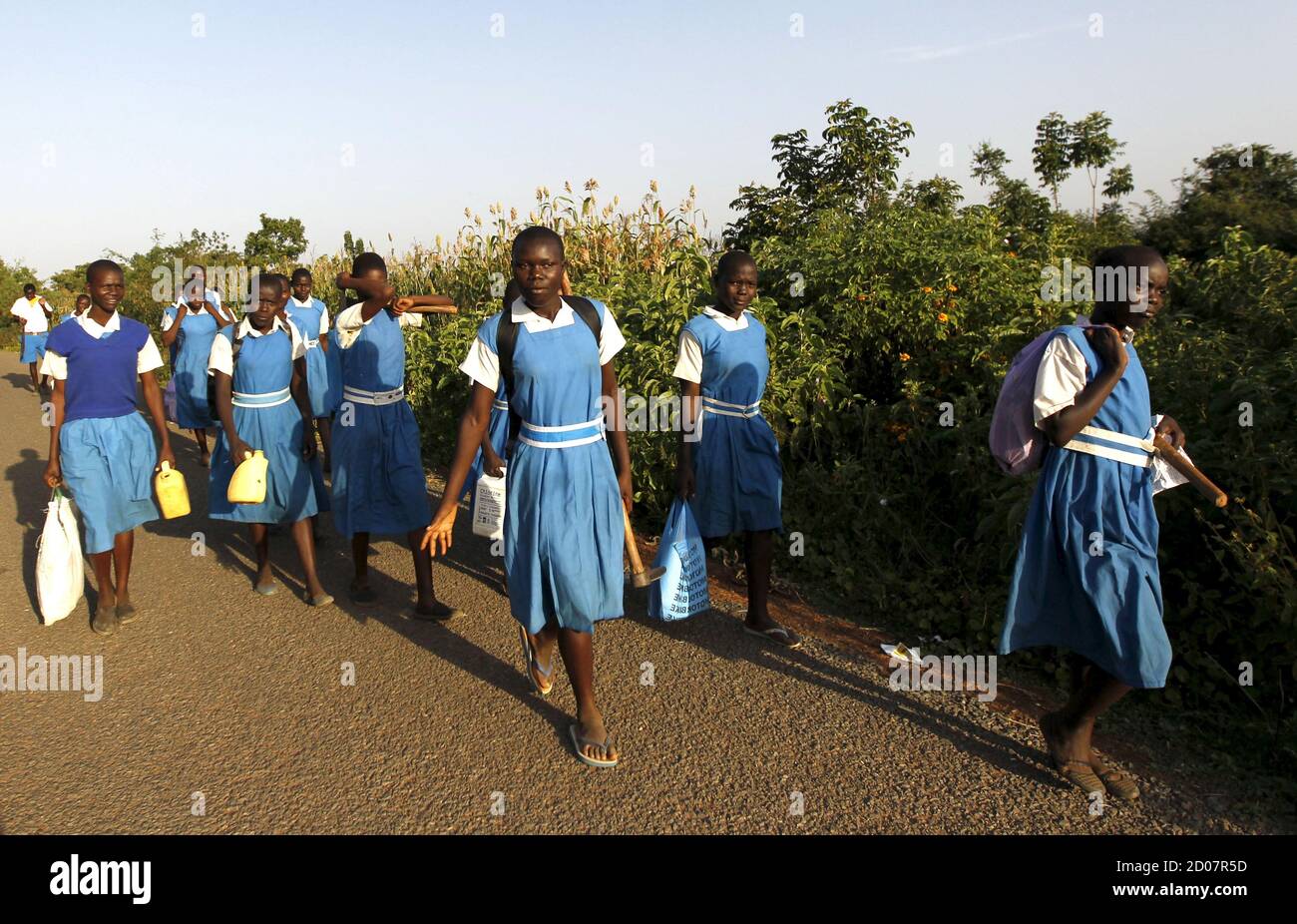 Pupils walk home from the Senator Barack Obama primary school in the U.S. President Barack Obama's ancestral village of Nyang'oma Kogelo, west of Kenya's capital Nairobi, July 14, 2015. President Obama visits Kenya and Ethiopia in July, his third major trip to Sub-Saharan Africa after travelling to Ghana in 2009 and to Tanzania, Senegal and South Africa in 2011. He has also visited Egypt, in North Africa, and South Africa for Nelson Mandela's funeral. Obama will be welcomed by a continent that had expected closer attention from a man they claim as their son, a sentiment felt acutely in the Ken Stock Photo