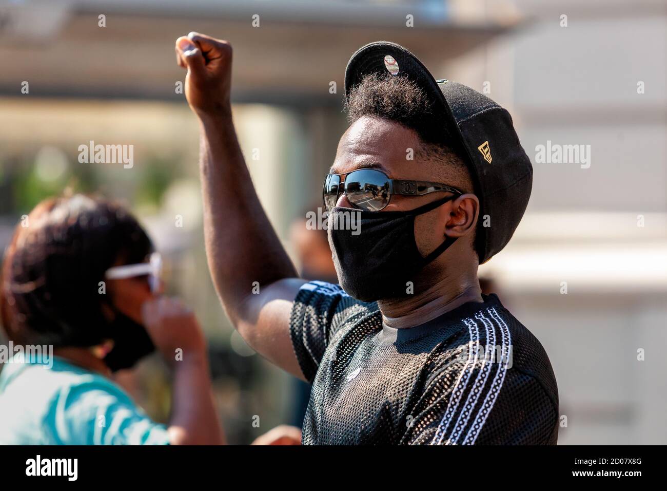 A participant in Let Freedom Sing, a sing-along protest march for Black lives, holds a fist high in solidarity, Washington, DC, United States Stock Photo