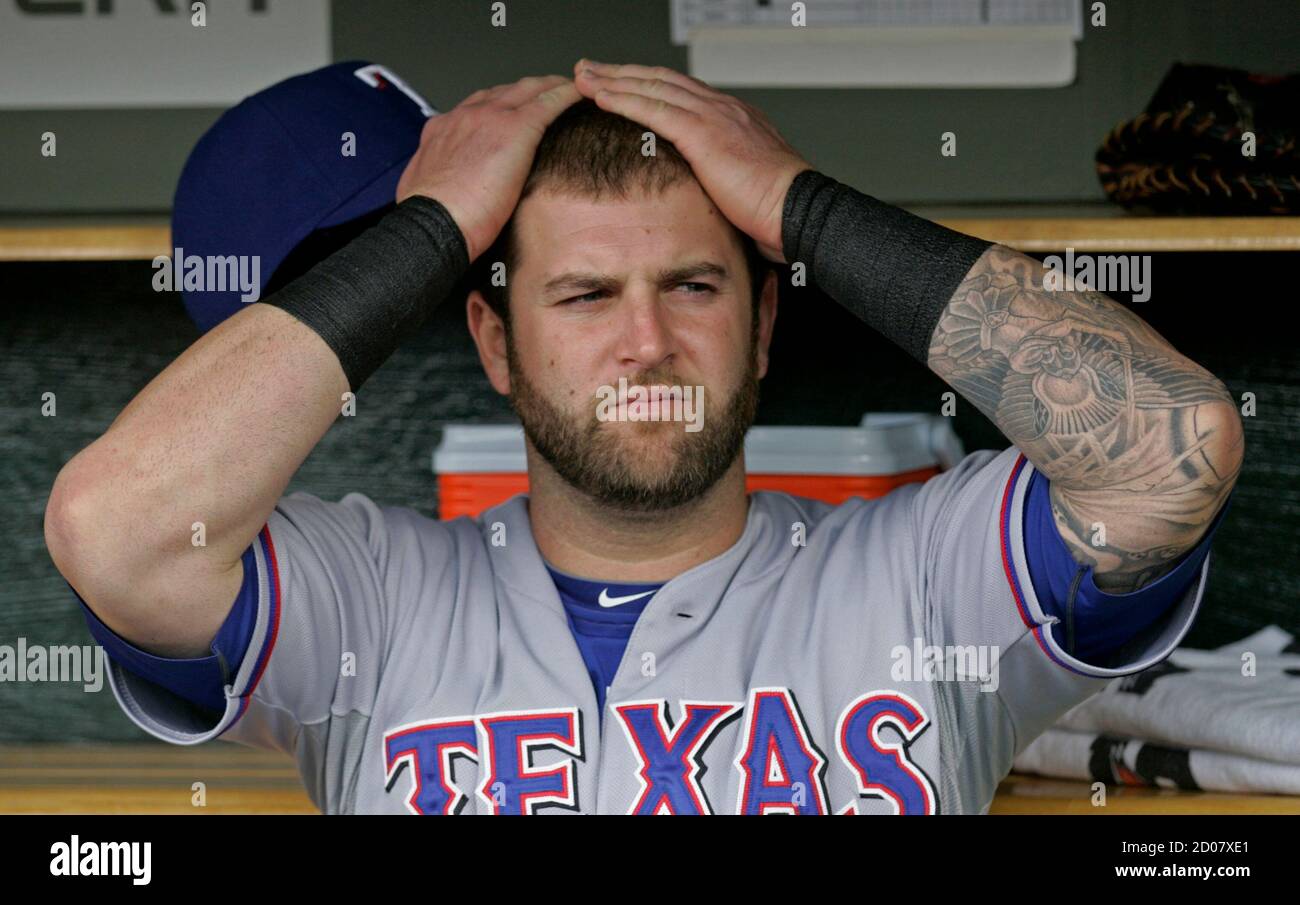 Texas Rangers catcher Mike Napoli sits in the dugout before his team met the Detroit Tigers in Game 5 in their MLB ALCS baseball playoffs in Detroit, Michigan, October 13, 2011.  REUTERS/Rebecca Cook (UNITED STATES  - Tags: SPORT BASEBALL) Stock Photo