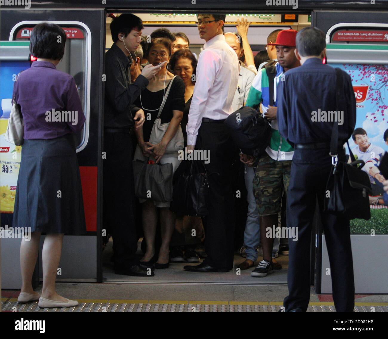 Commuters Take The Train During Morning Peak Hour In Singapore January 29 2013 Singapore Wants To Raise Its Population By As Much As 30 Percent In The Next Two Decades To Ensure<script async src=