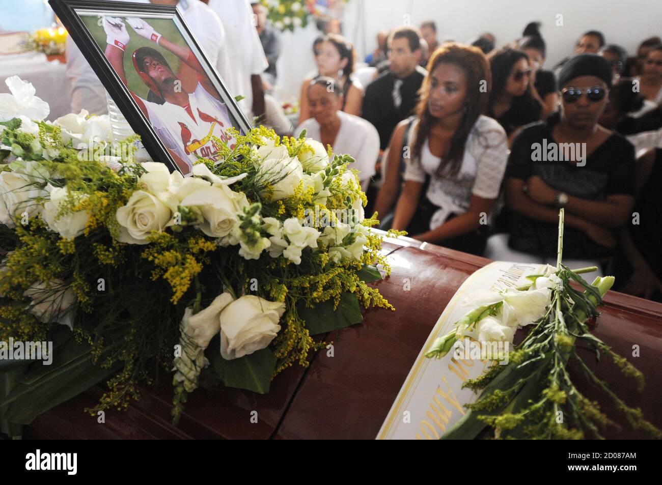 Family and friends of St. Louis Cardinals' outfielder Oscar Taveras attend his funeral in the town of Sosua, Puerto Plata province, October 28, 2014. Taveras, 22, was killed Sunday night along with Yamaly Arvelo, 18, while driving a 2014 Chevrolet Camaro on the tourist road Sosua-Puerto Plata on the north coast of Dominican Republic, police said. St. Louis Cardinals manager Mike Matheny on Monday called the death of Oscar Taveras, a top prospect killed in a car accident, "a horrible loss of a life." REUTERS/Ricardo Rojas (DOMINICAN REPUBLIC - Tags: SPORT BASEBALL OBITUARY) Stock Photo