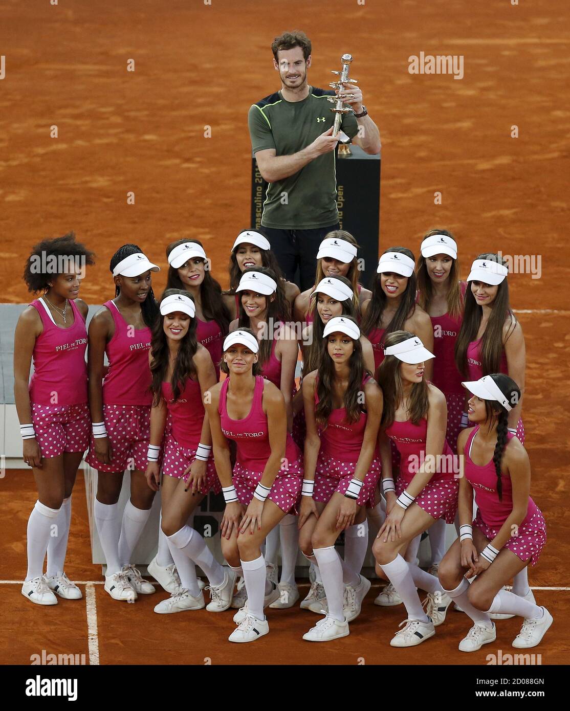 Britain's Andy Murray poses with his trophy behind ballgirls after winning  against Spain's Rafael Nadal their final match at the Madrid Open tennis  tournament in Madrid, Spain, May 10, 2015. REUTERS/Andrea Comas