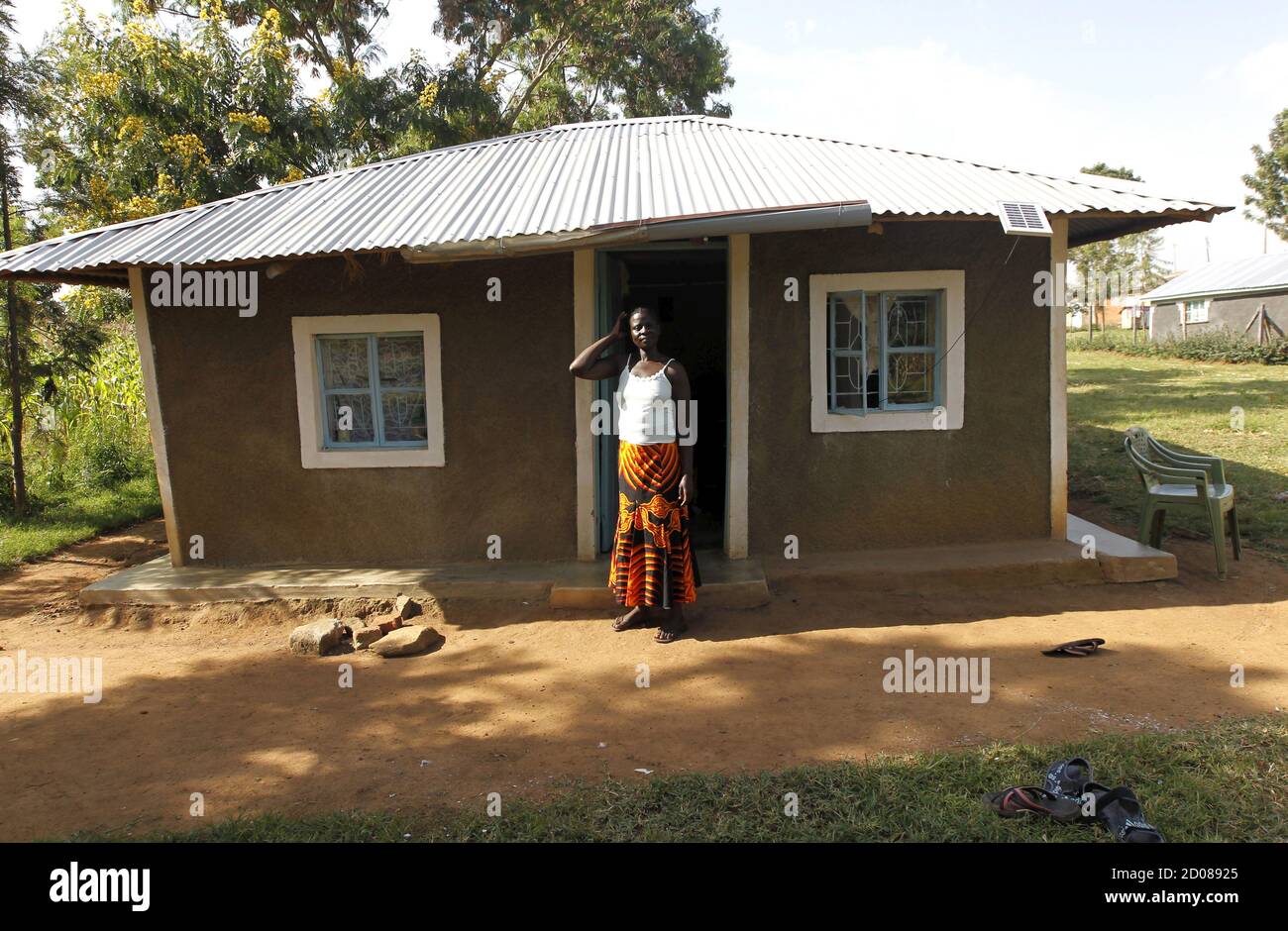Peris Aoko, a 37-year-old housewife, poses for a photograph outside her home in Kogelo, west of Kenya's capital Nairobi, July 15, 2015. Aoko said, 'We expect the U.S. president to come home as a son of this land. Kogelo is the 53rd State of the United States of America.' As U.S. President Barack Obama visits Kenya, a personal connection to his father's birthplace of Kogelo dominates a trip that Kenyans view as a native son returning home. Residents from a herdsman to a housewife share their views on what Obama has achieved and what they would like to see next. REUTERS/Thomas Mukoya  PICTURE 4  Stock Photo