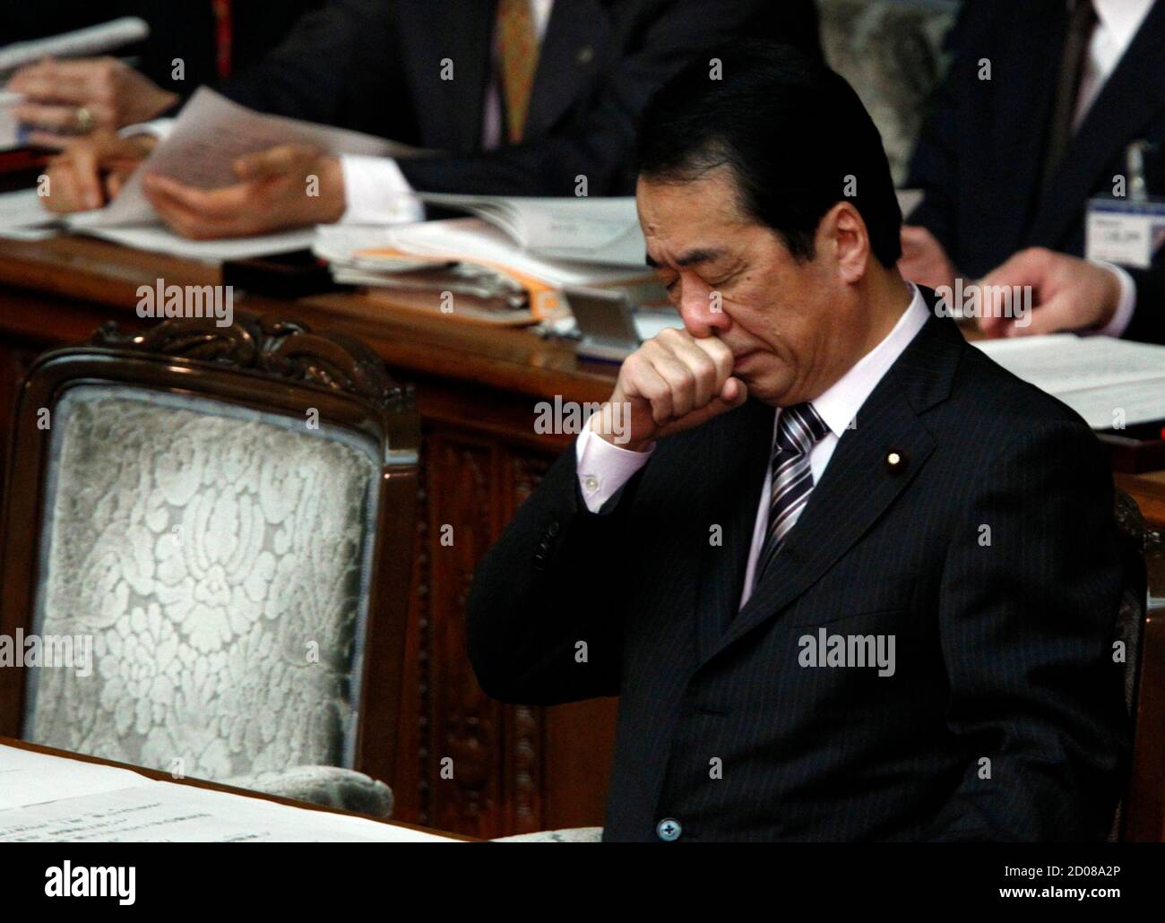 Japan's Prime Minister Naoto Kan attends the start of a regular parliament session at the lower house of parliament in Tokyo January 24, 2011. Kan, facing a divided parliament and doubts over his political survival, on Monday stepped up his campaign for a sales tax rise he argues is vital to pay for huge welfare costs in the fast-ageing society. REUTERS/Issei Kato (JAPAN - Tags: POLITICS BUSINESS) Stock Photo