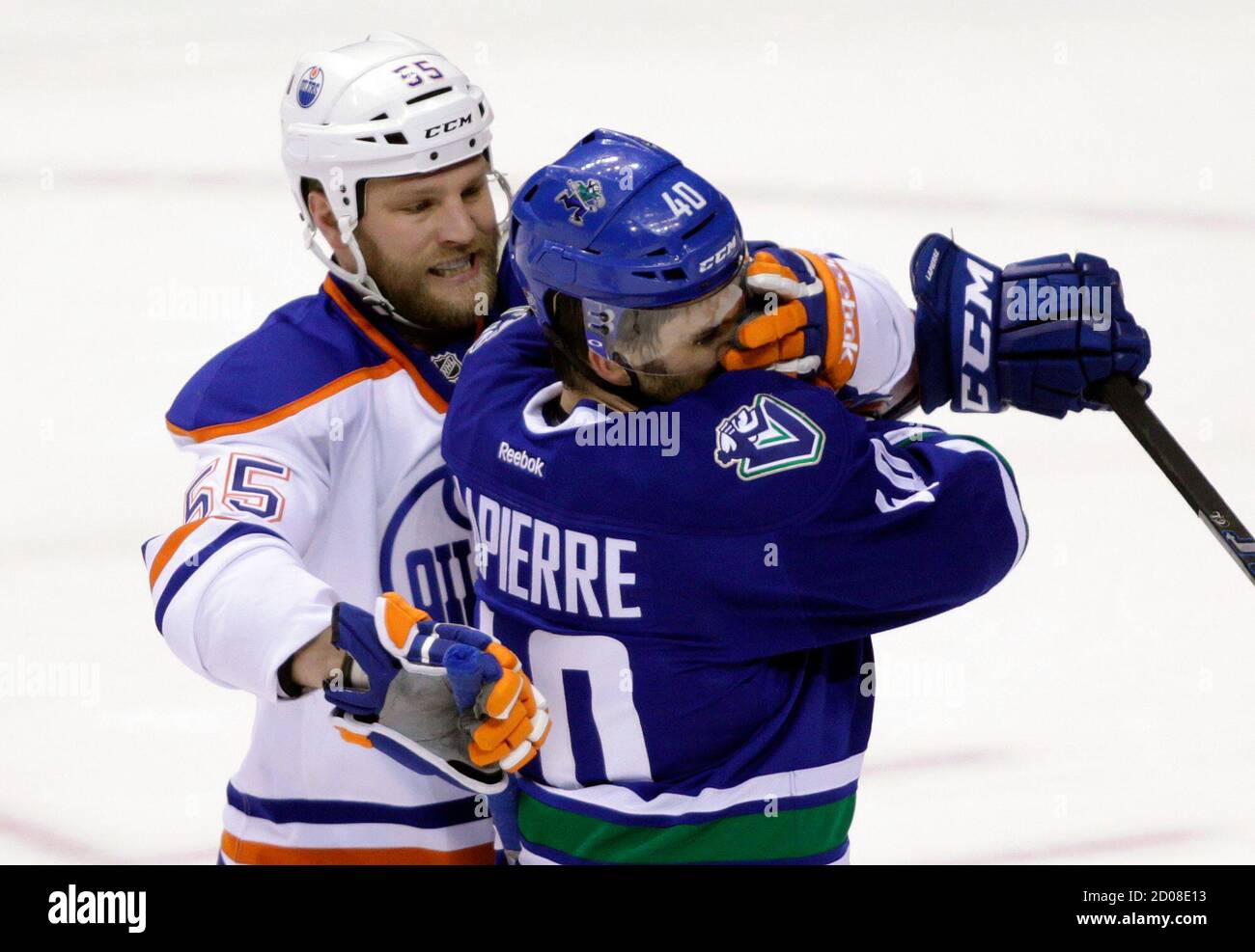 Vancouver Canucks' Maxim Lapierre (R) is roughed up by Edmonton Oilers' Ben Eager during the second period of their NHL hockey game in Vancouver, British Columbia April 7, 2012. REUTERS/Ben Nelms (CANADA - Tags: SPORT ICE HOCKEY) Stock Photo