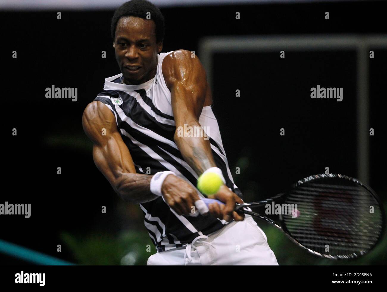 Gael Monfils of France returns a shot to compatriot Gilles Simon during  their quarter-final match at the Thailand Open 2012 tennis tournament in  Bangkok September 28, 2012. REUTERS/Chaiwat Subprasom (THAILAND - Tags: