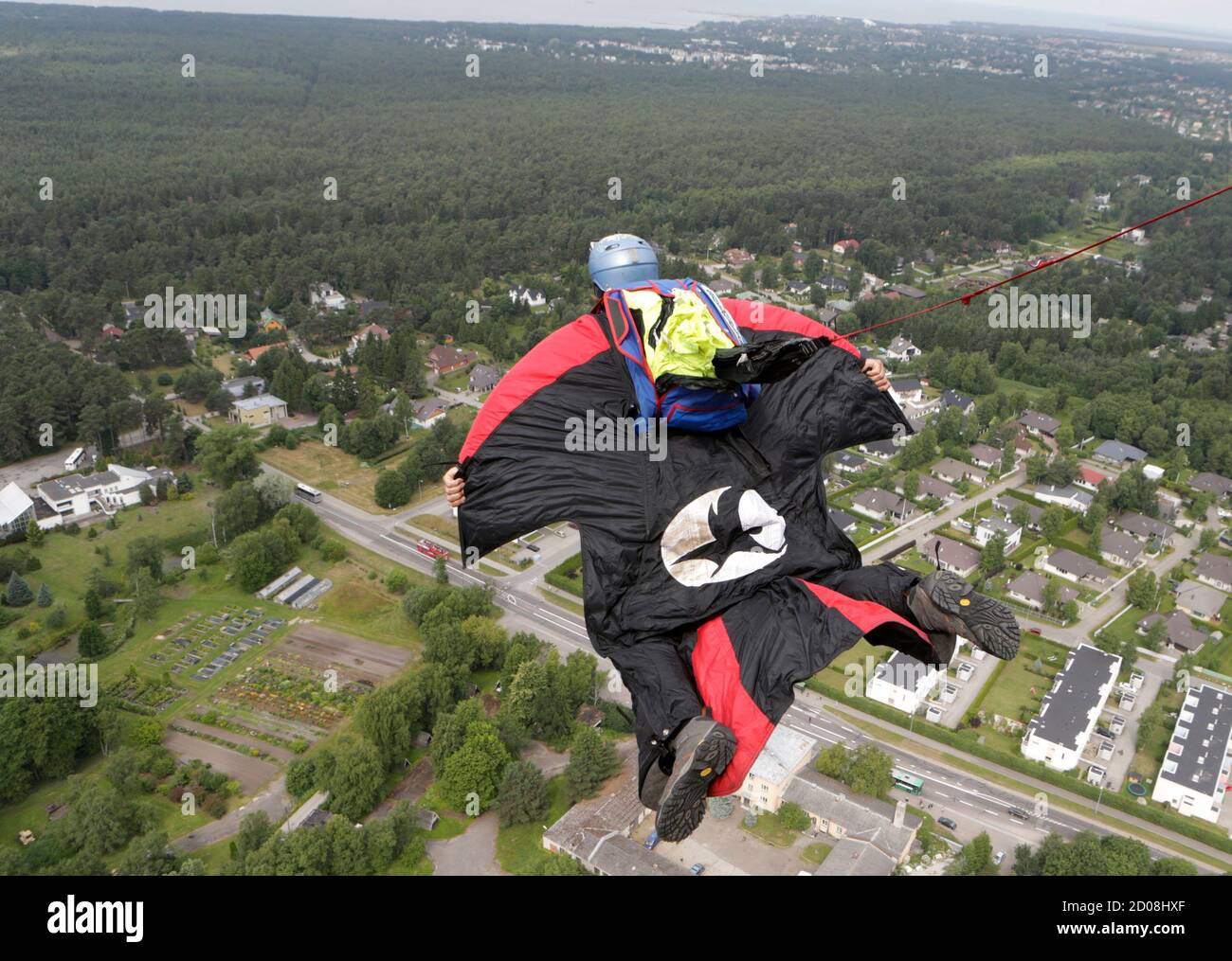 BASE jumper Semjon Lazarev of Russia wears an outfit modelled after a Batman  suit as he leaps before opening his parachute during Tallinn TV Tower  B.A.S.E. Boogie 2013 event July 11, 2013.