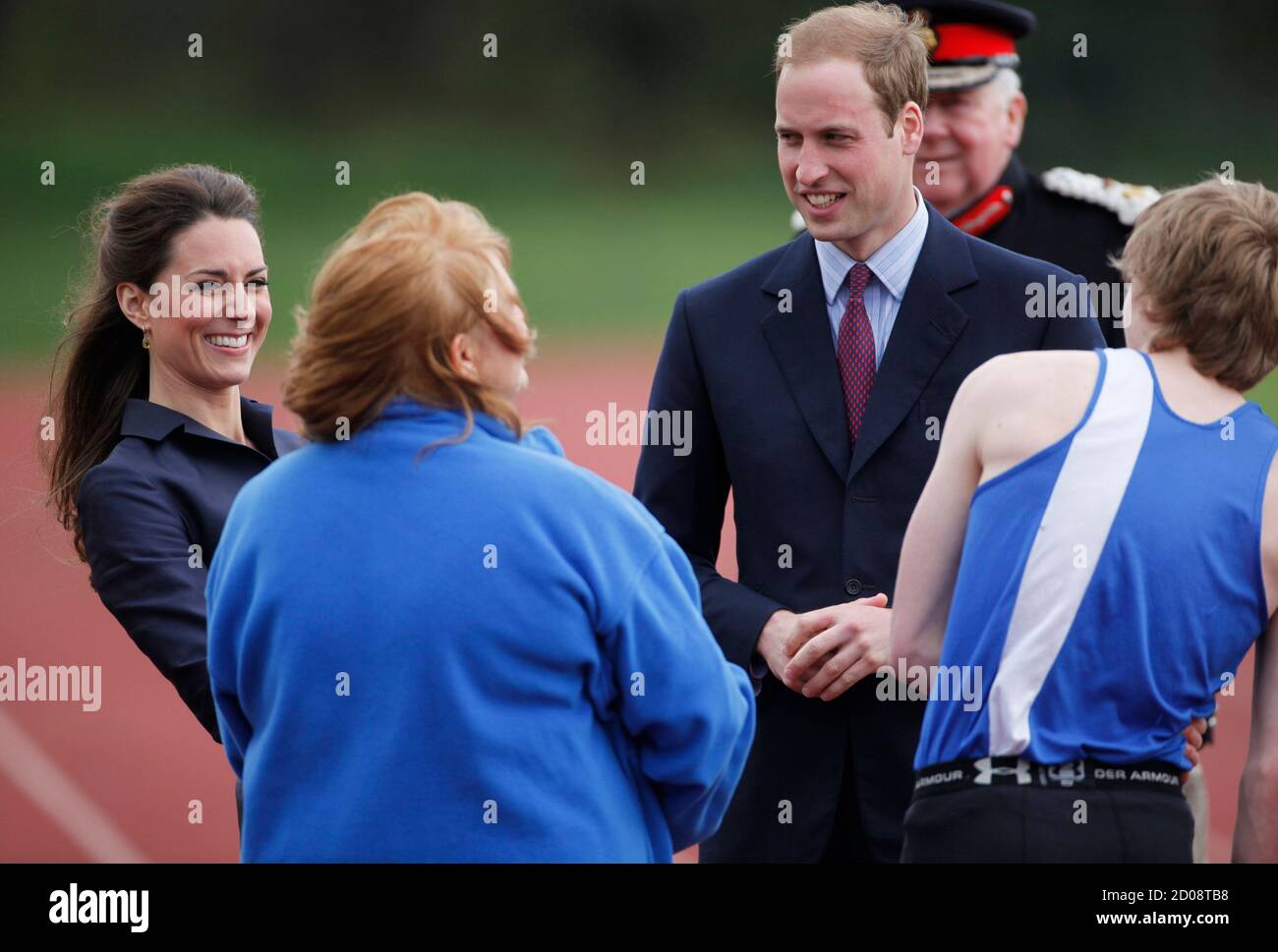 Britain's Prince William (3rd L) and his fiancee, Kate Middleton (L), talk  to young athletes and staff during their visit to Witton Country Park in  Darwen, northern England April 11, 2011. A
