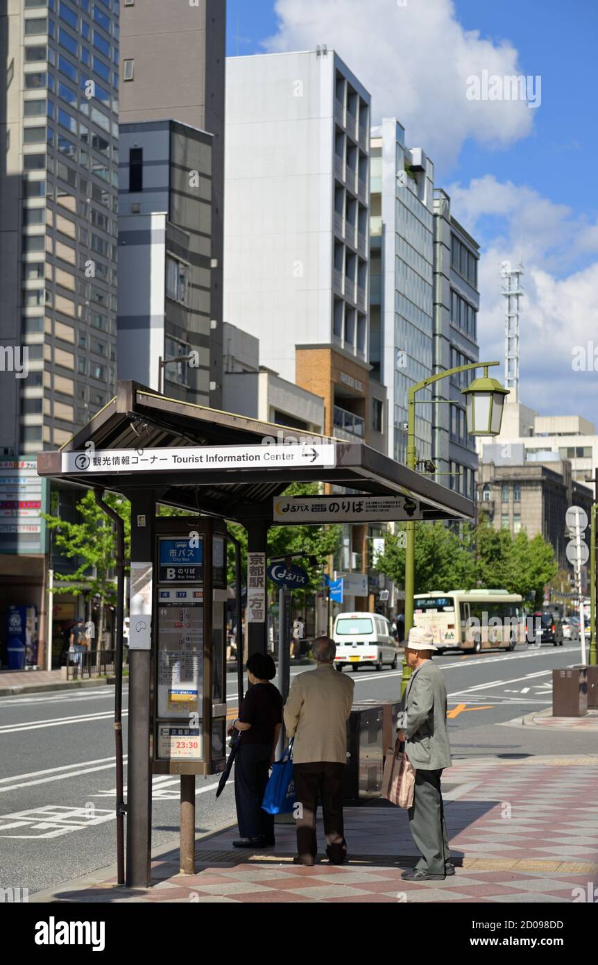 Japanese seniors waiting at a bus stop, Kyoto JP Stock Photo