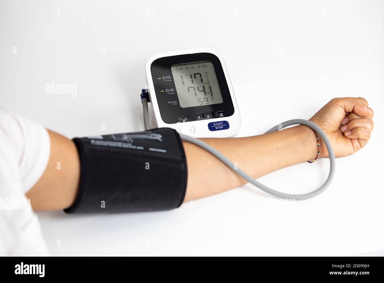 Woman measuring his own blood pressure, white background Stock Photo