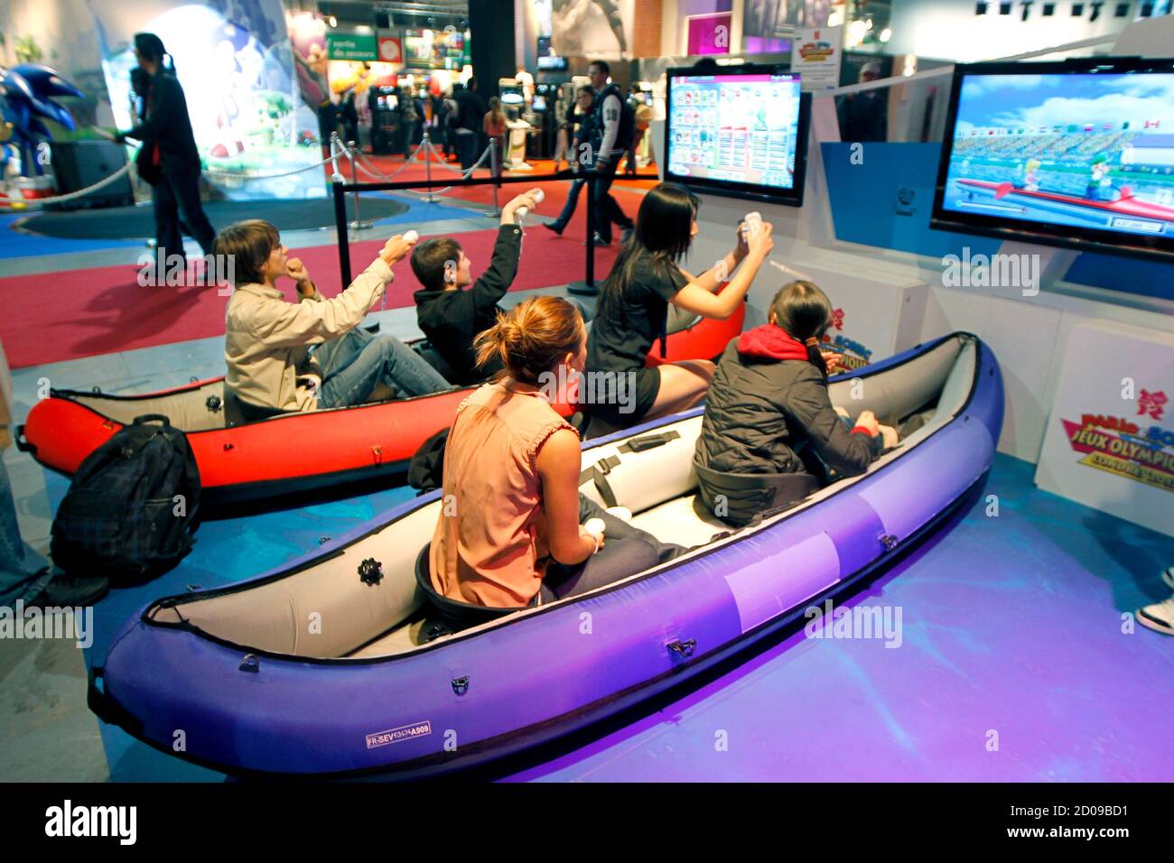 Visitors play a rowing race with Wii games during a visit at the Paris  Games Week show in Paris October 21, 2011. The Paris Games Week will run  from October 21 to