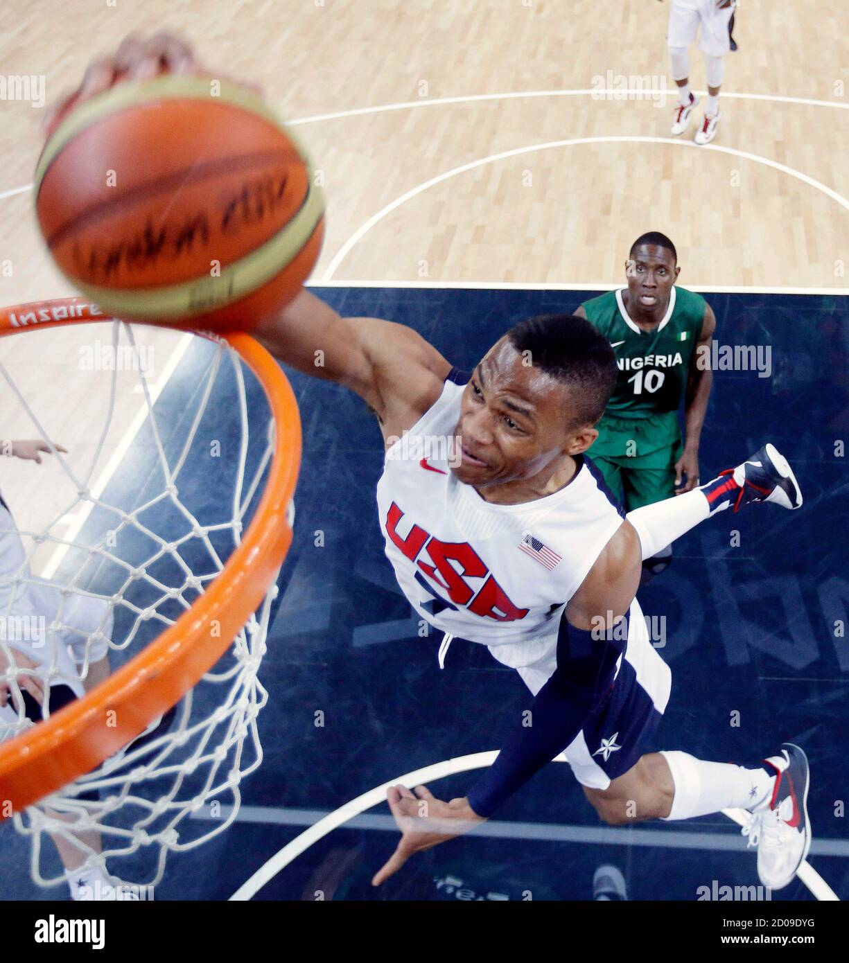 Russell Westbrook (R) of the U.S. scores against Nigeria during their men's  preliminary round Group A basketball match at the Basketball Arena during  the London 2012 Olympic Games August 2, 2012. REUTERS/Eric