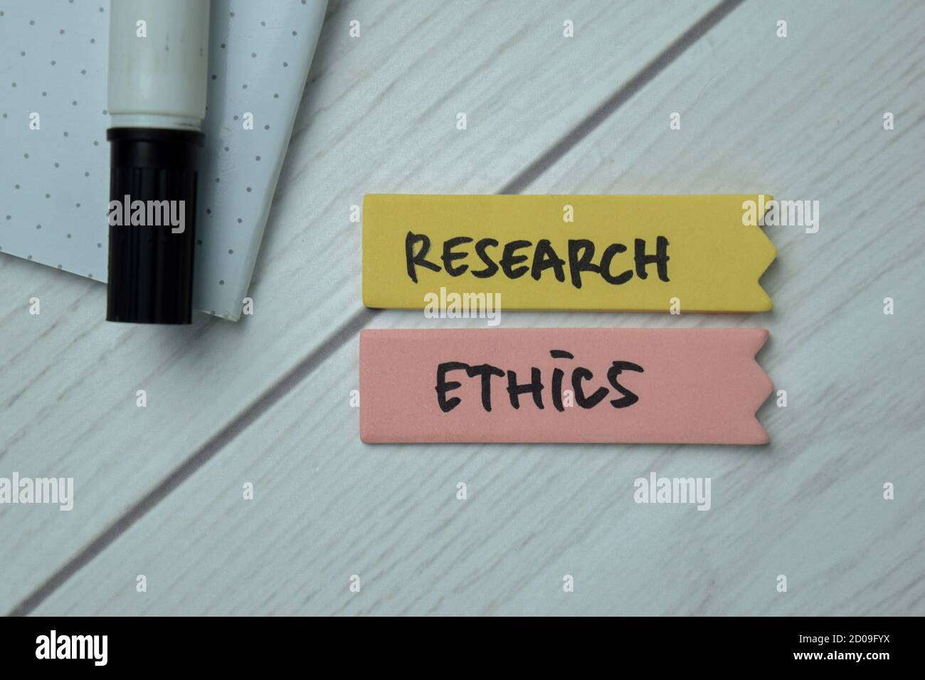 Research Ethics text on sticky notes isolated on office desk Stock Photo