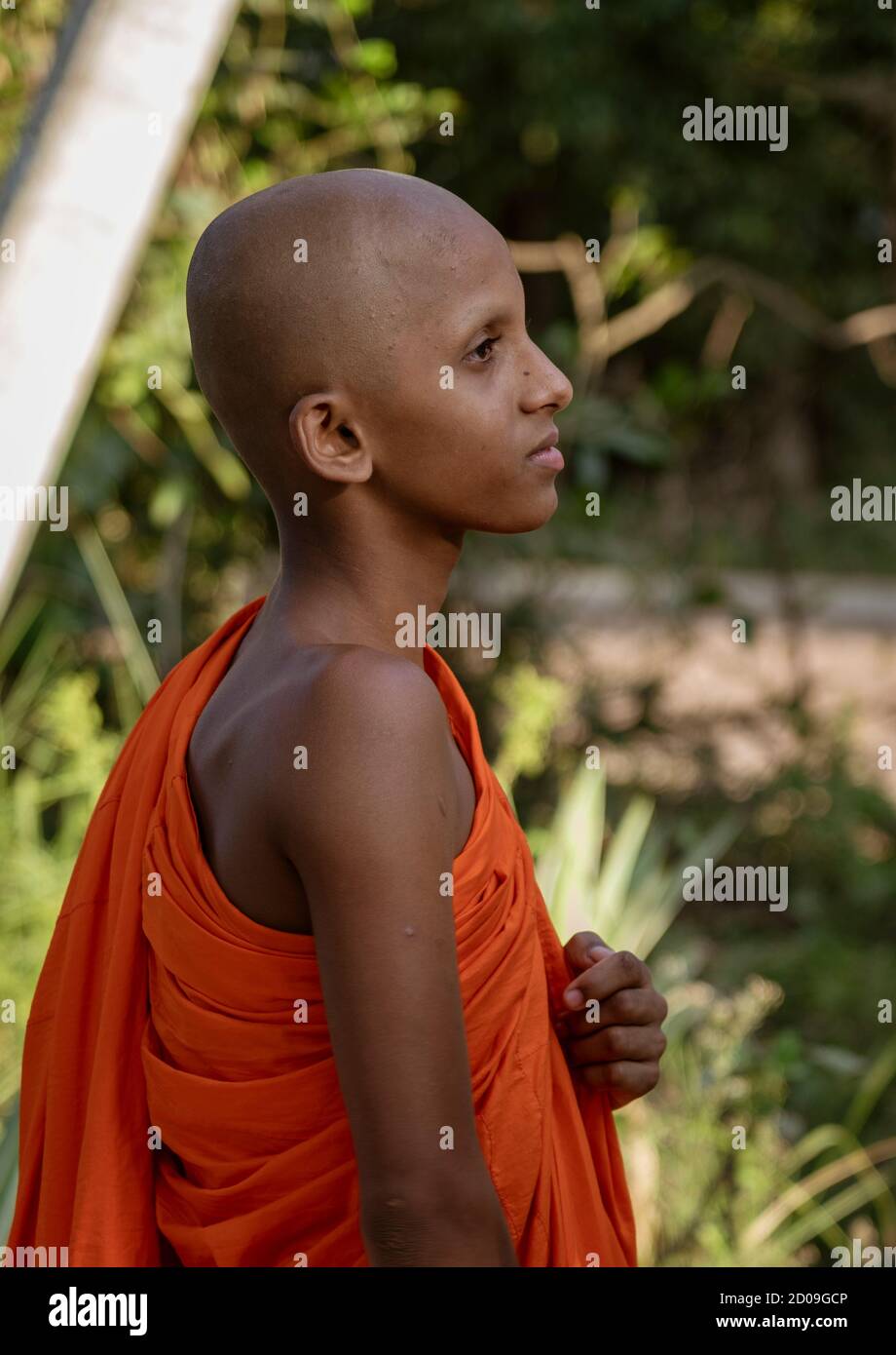 ED-Negombo, Sri Lanka - 2019-03-22 - Lone Young Monk Looks Off Into Distance. Stock Photo