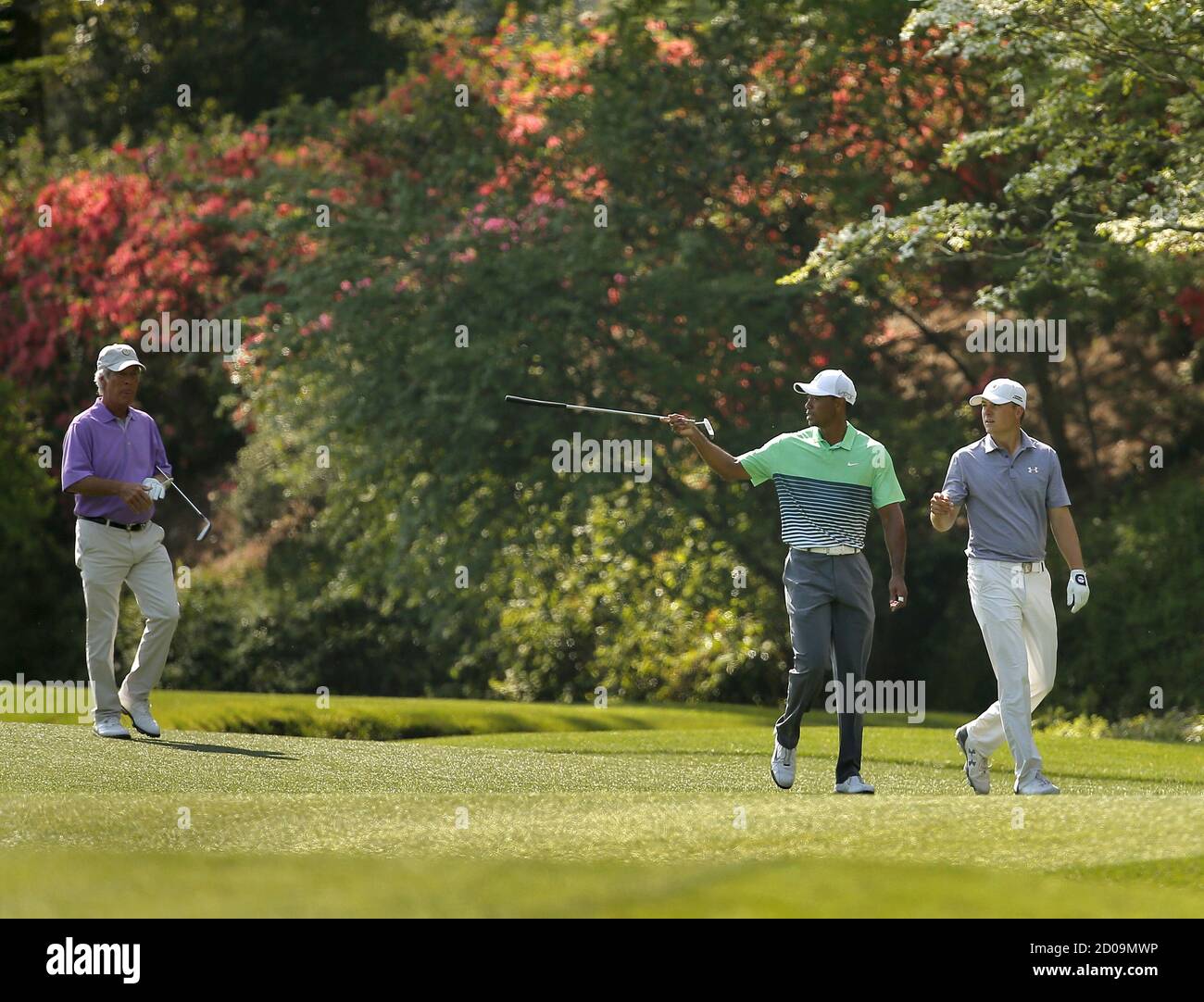 Jordan Spieth (R) gets some pointers from Tiger Woods as they walk up the 13th fairway with Ben Crenshaw (L) during a practice  round ahead of the 2015 Masters at Augusta National Golf Course in Augusta, Georgia April 8, 2015. Spieth's sublime putting on some of the most treacherous greens in golf, which set up his Masters victory on Sunday, was underpinned by his imaginative touch, says putting maestro Crenshaw. Picture taken April 8, 2015. REUTERS/Brian Snyder Stock Photo