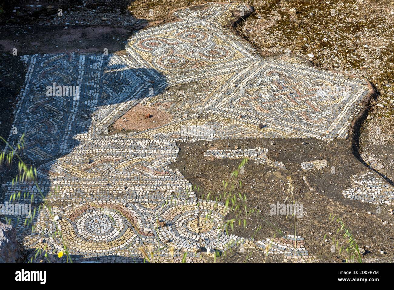 Ancient Greek mosaic in Library of Hadrian, Athens, Greece. Beautiful patterned ornament floor in old ruins background. Remains of architecture of cla Stock Photo