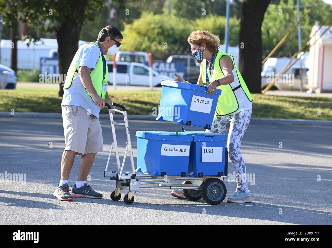 Austin, Texas, USA. 2nd Oct 2020. Travis County elections officials collect boxes with mail-in ballots dropped off by voters in person as voting starts in Texas for the contentious presidential contest as well as other races. Credit: Bob Daemmrich/Alamy Live News Stock Photo