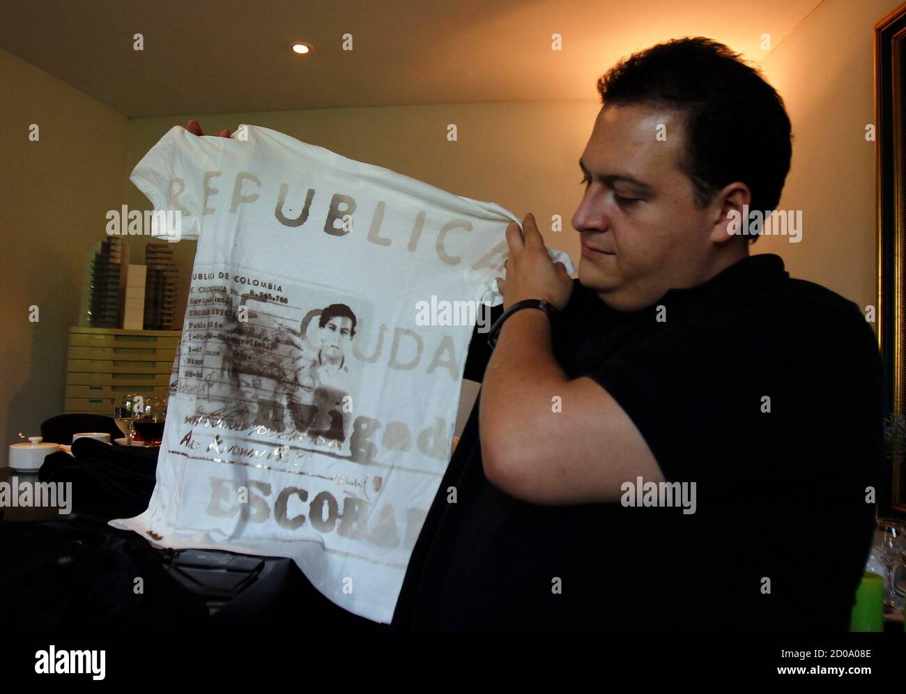 Sebastian Marroquin, son of deceased Colombian drug lord Pablo Escobar  Gaviria, shows a t-shirt of his company's design with an image of his  father stamped on it during an interview with Reuters