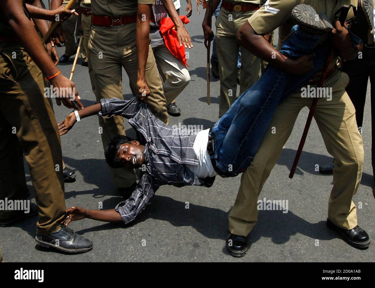 Police detain a college student during a protest in the southern Indian city of Chennai March 21, 2013. Students in Chennai staged a protest demanding the Indian government to take a stringent stand against the "war crimes" committed during Sri Lanka's civil war which ended in 2009. Sri Lankan President Mahinda Rajapaksa is under fire from the U.N. Human Rights Council, which last year adopted a United States-sponsored resolution demanding that Sri Lanka ensure government troops who committed war crimes during the final stages of its war against Tamil rebels are brought to justice. REUTERS/Bab Stock Photo