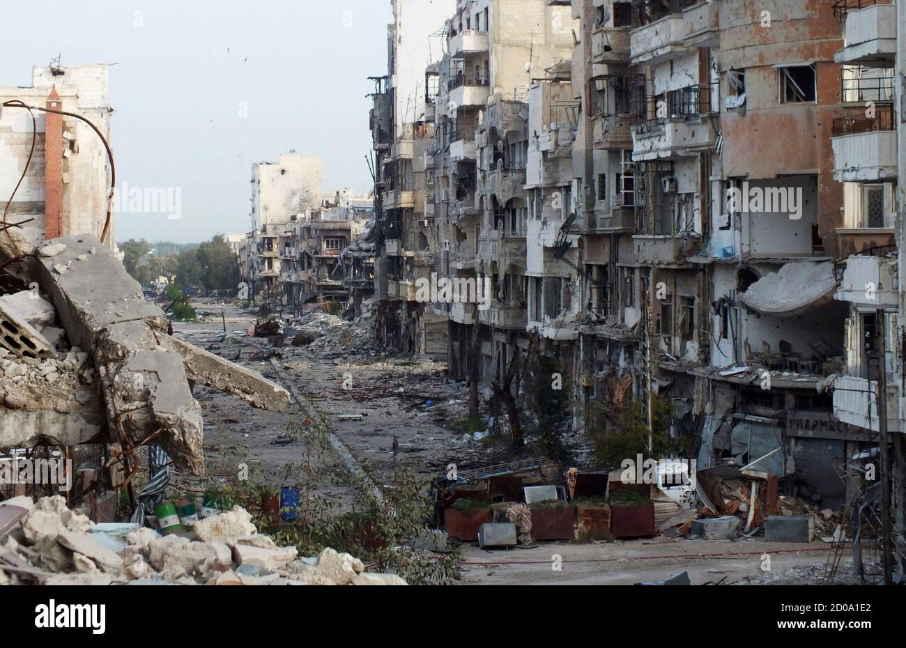 Destroyed buildings are seen on a deserted street in Jouret al Shayah area in Homs, April 8, 2013. REUTERS/Yazan Homsy (SYRIA - Tags: POLITICS CIVIL UNREST) Stock Photo
