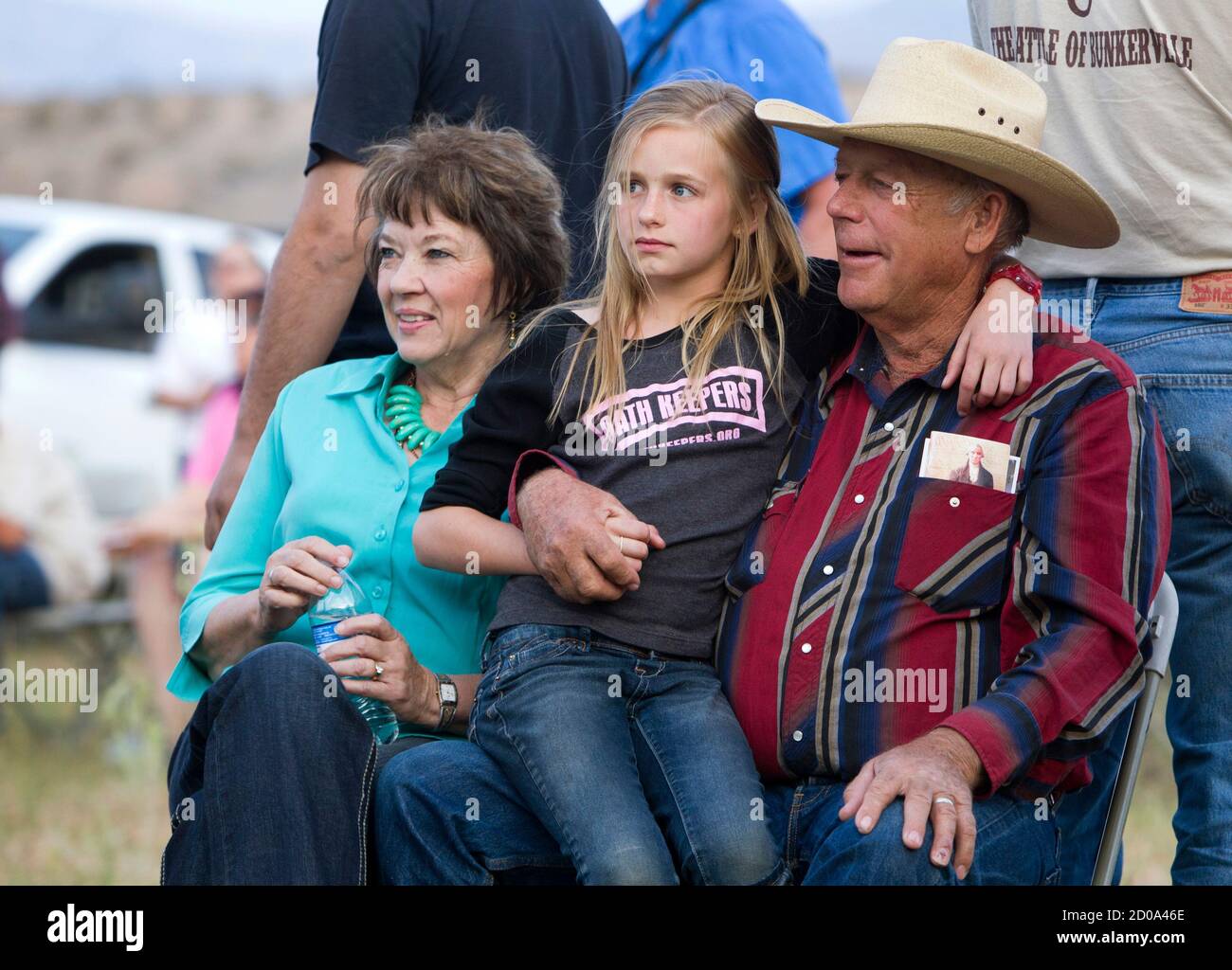 Rancher Cliven Bundy, his wife Carol (L) and his granddaughter Jerusha Bundy  (C), 10, listen to live music during a Bundy family "Patriot Party" near  Bunkerville, Nevada, about 80 miles from Las