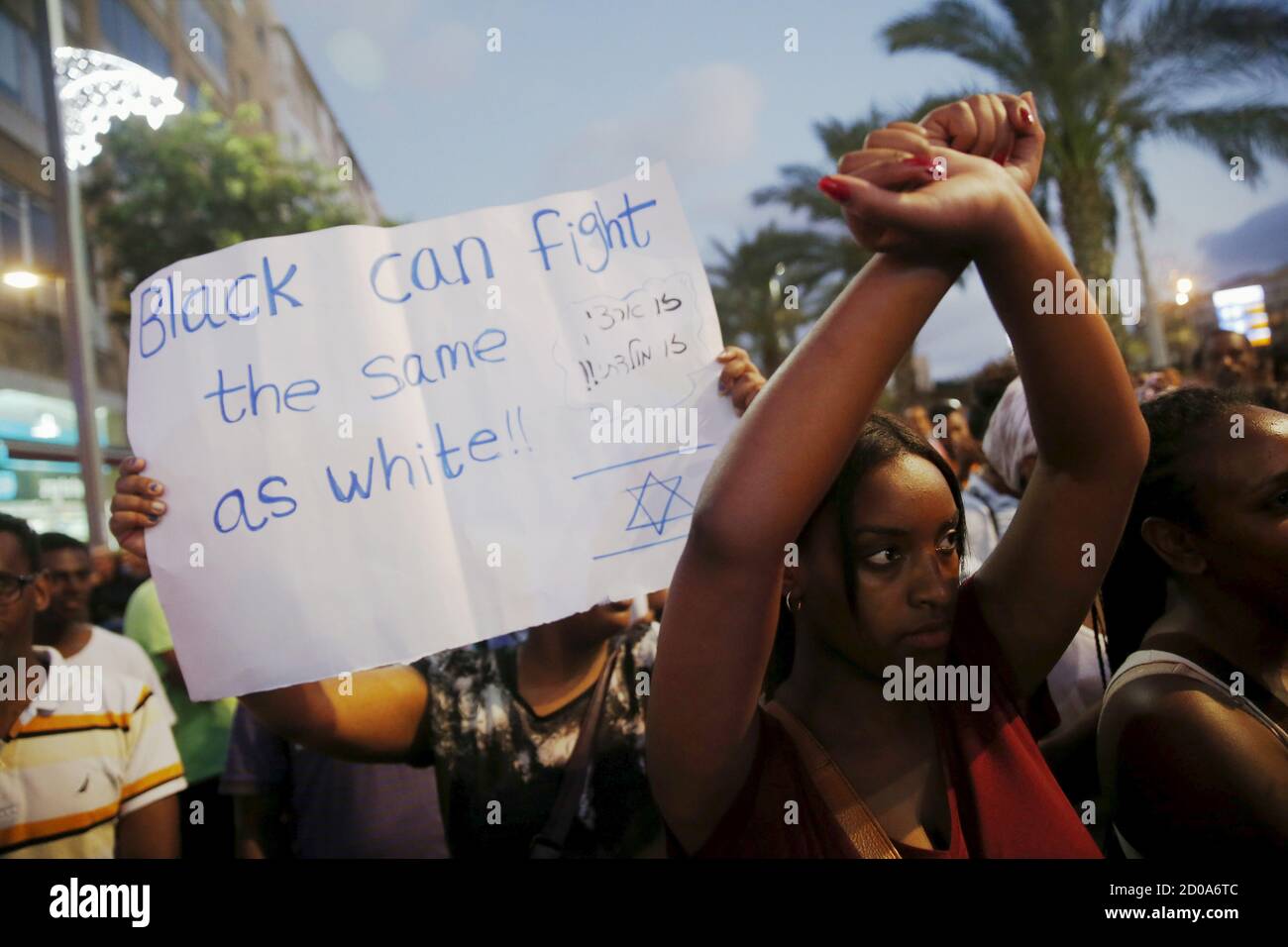 A protester, who is an Israeli Jew of Ethiopian origin, holds her hands up during a demonstration against what they say is police racism and brutality in Tel Aviv June 22, 2015. REUTERS/Baz Ratner Stock Photo