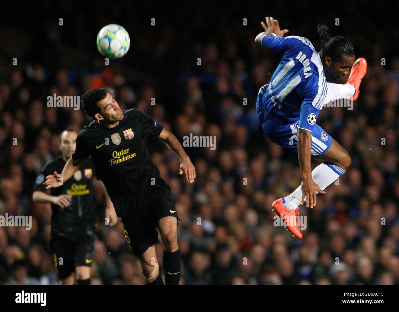 Didier Drogba R Of Chelsea And Sergio Busquets Of Barcelona Jump For A Header During Their Champions League Semi Final First Leg Soccer Match At Stamford Bridge In London April 18 12 Reuters Albert