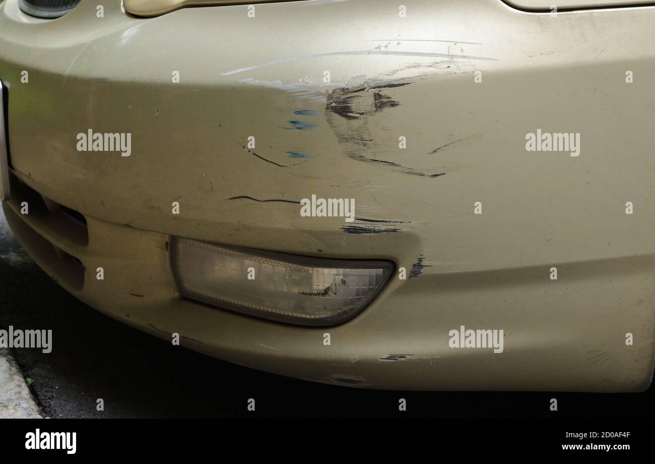The front of sedan car was damaged by scratching during accident Stock Photo