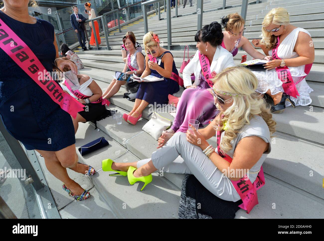 Racegoers Study The Racecard On Ladies Day The Second Day Of The Grand National Horse Racing